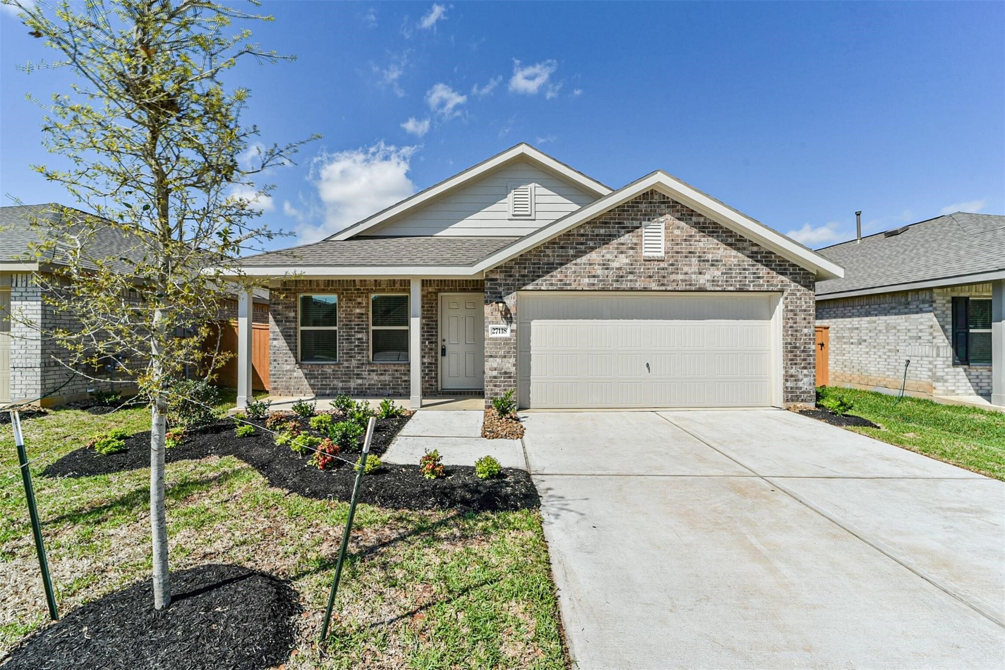 Welcome Home. Front exterior view featuring professional landscaping and a charming brick and stone elevation. Welcome Home. Front exterior view featuring professional landscaping and a charming brick and stone elevation.