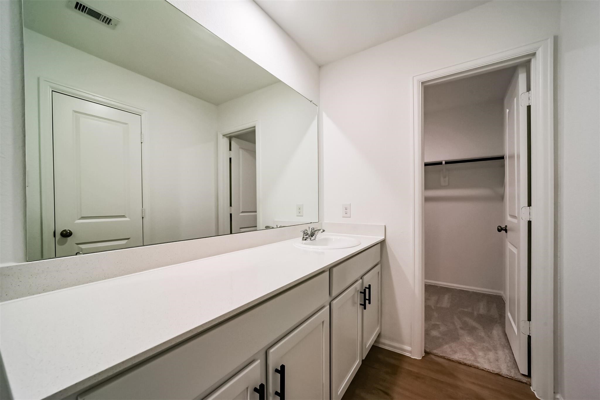 primary bathroom featuring a relaxing soaking tub, separate shower, and a large vanity