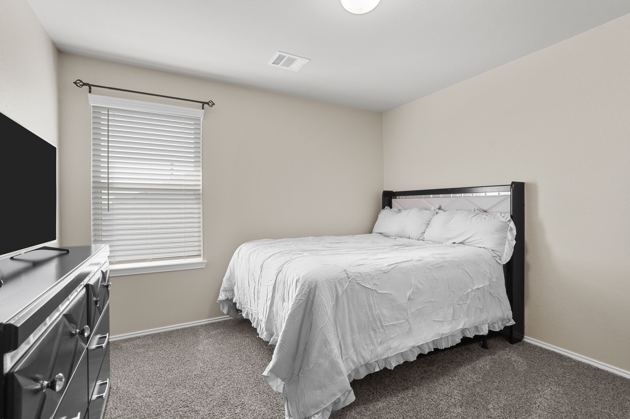 Upstairs Bedroom 2: A bright and inviting space, perfect for family or guests.