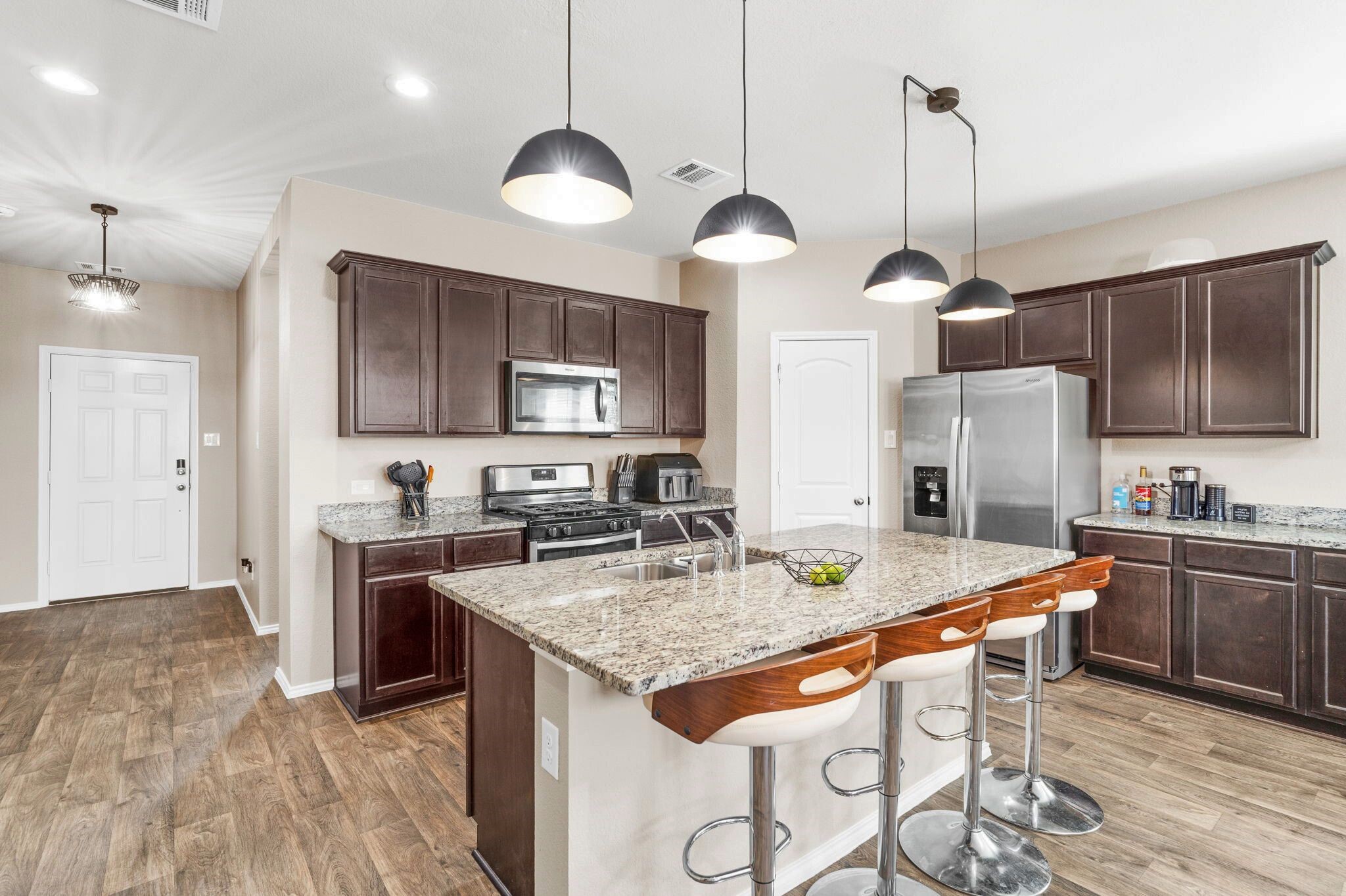 The kitchen island includes a convenient seating area, perfect for casual meals, conversation, or keeping the cook company.