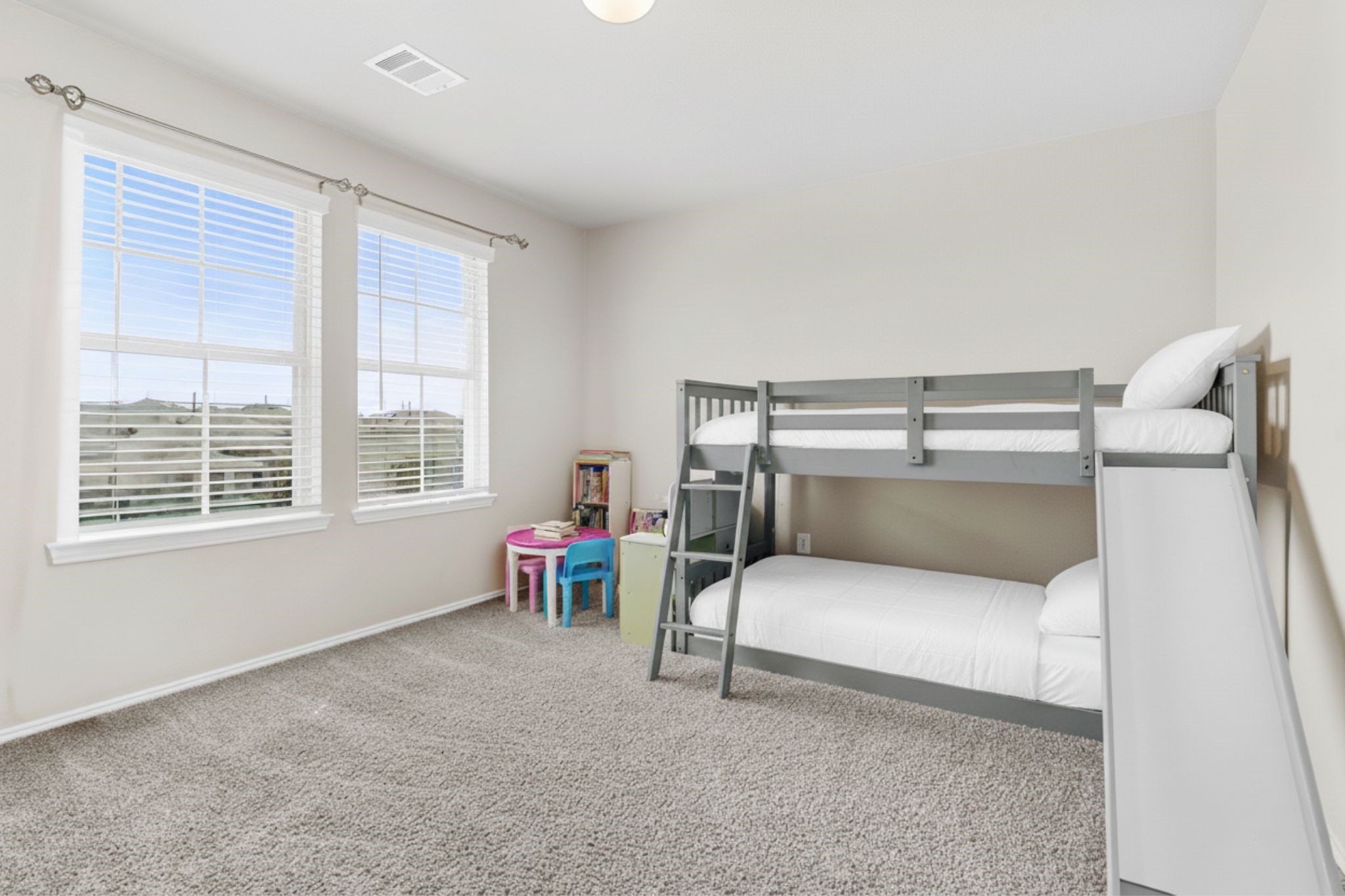 Upstairs Bedroom 1: Spacious and fun, ideal for a childs bedroom or play area.