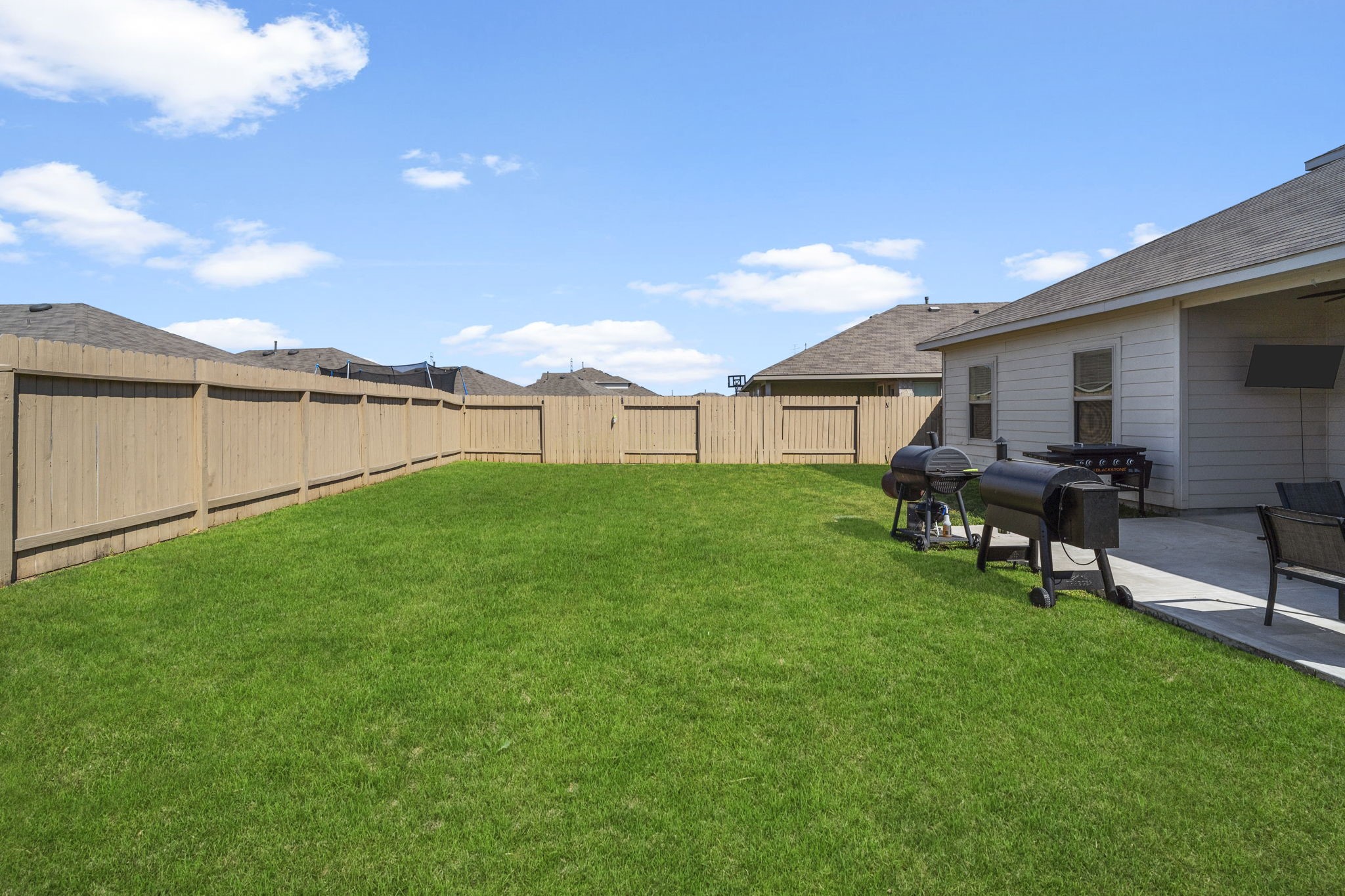 Fully fenced and full of possibilities, the spacious backyard features an extended patio, ideal for grilling, entertaining, or enjoying time with family and friends.
