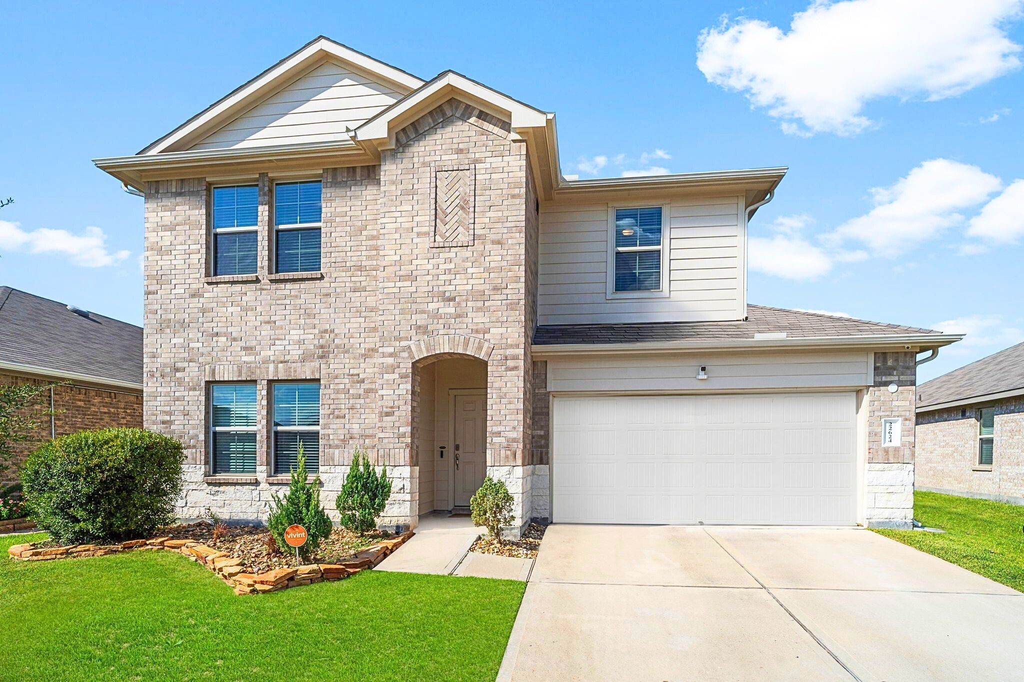 Welcome Home! A mix of brick and stone gives the home a classic look, while the well-kept lawn adds a warm, inviting feel.