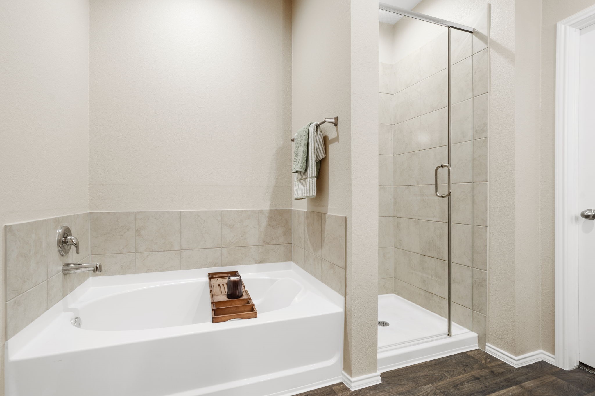 Relax in the deep soaking tub or start your day refreshed in the glass-enclosed shower. Dual sinks and a separate vanity area make the primary ensuite both functional and stylish.