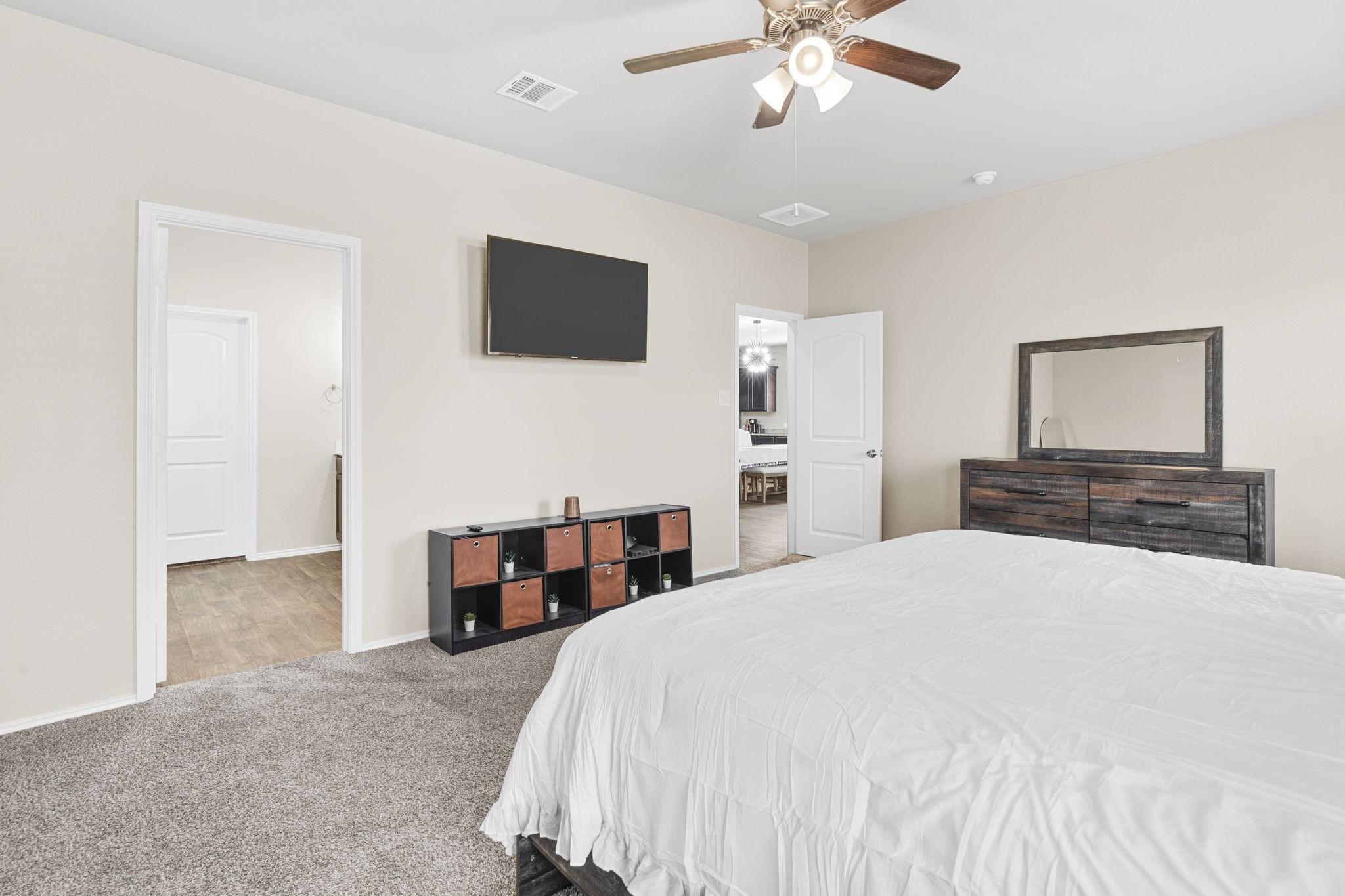 The primary bedroom is conveniently located downstairs and offers a spacious, serene retreat.
