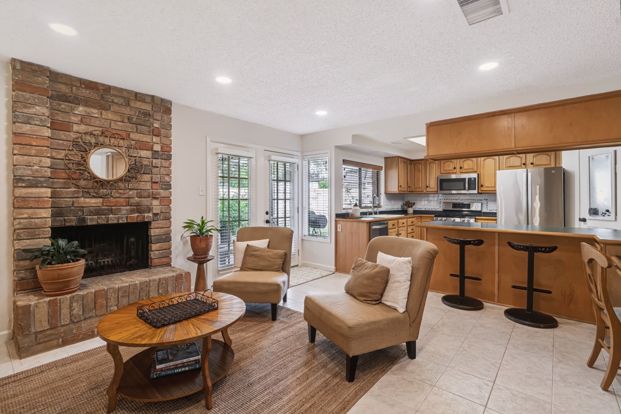 The comfortable floor plan features a cozy gas-log fireplace, custom built-in cabinetry, and a family room that opens to the kitchen, creating an ideal space for everyday living and entertaining.