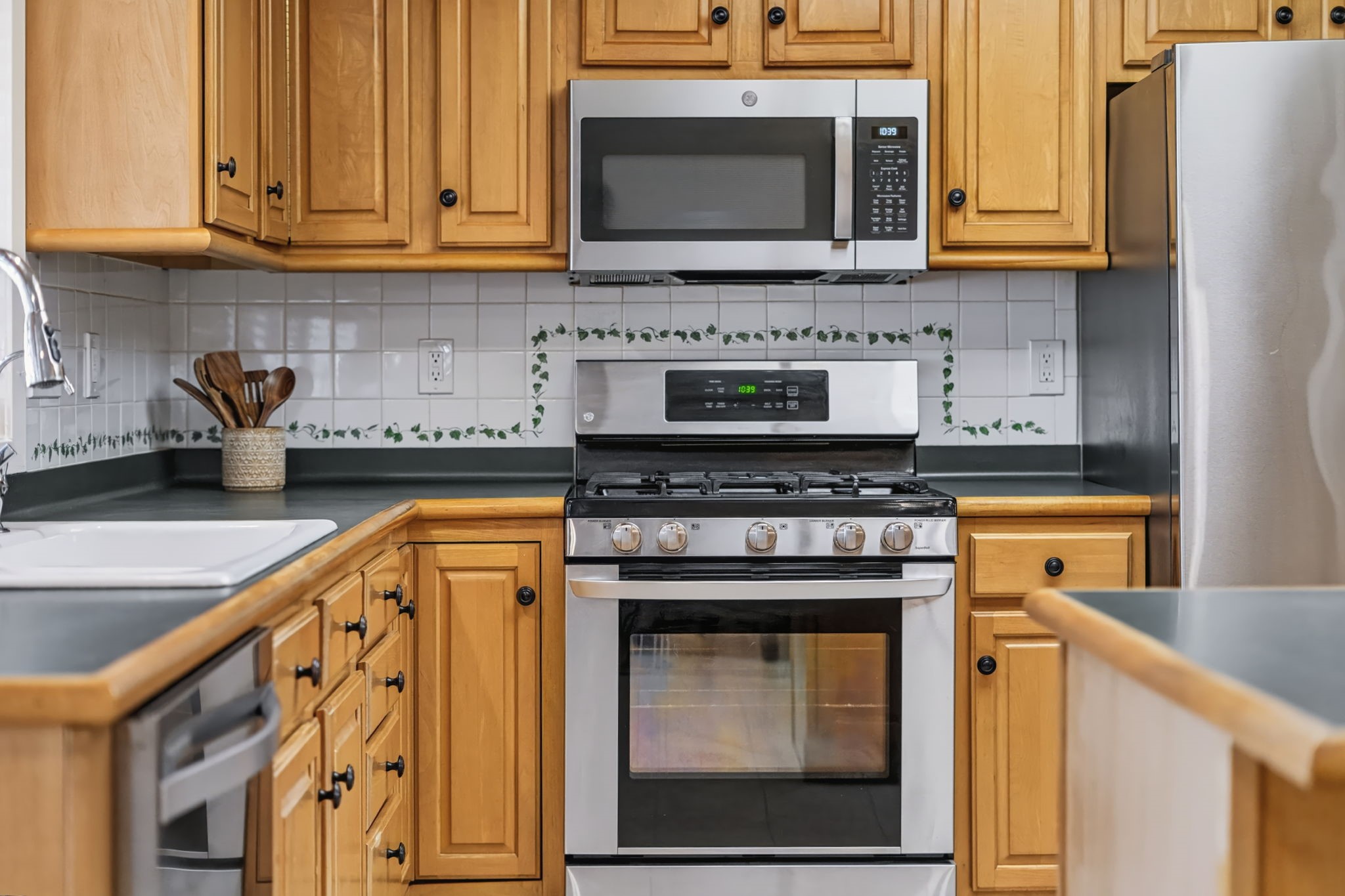 Well-maintained stainless steel appliances include a gas range, dishwasher, and a built-in microwave updated in 2025.