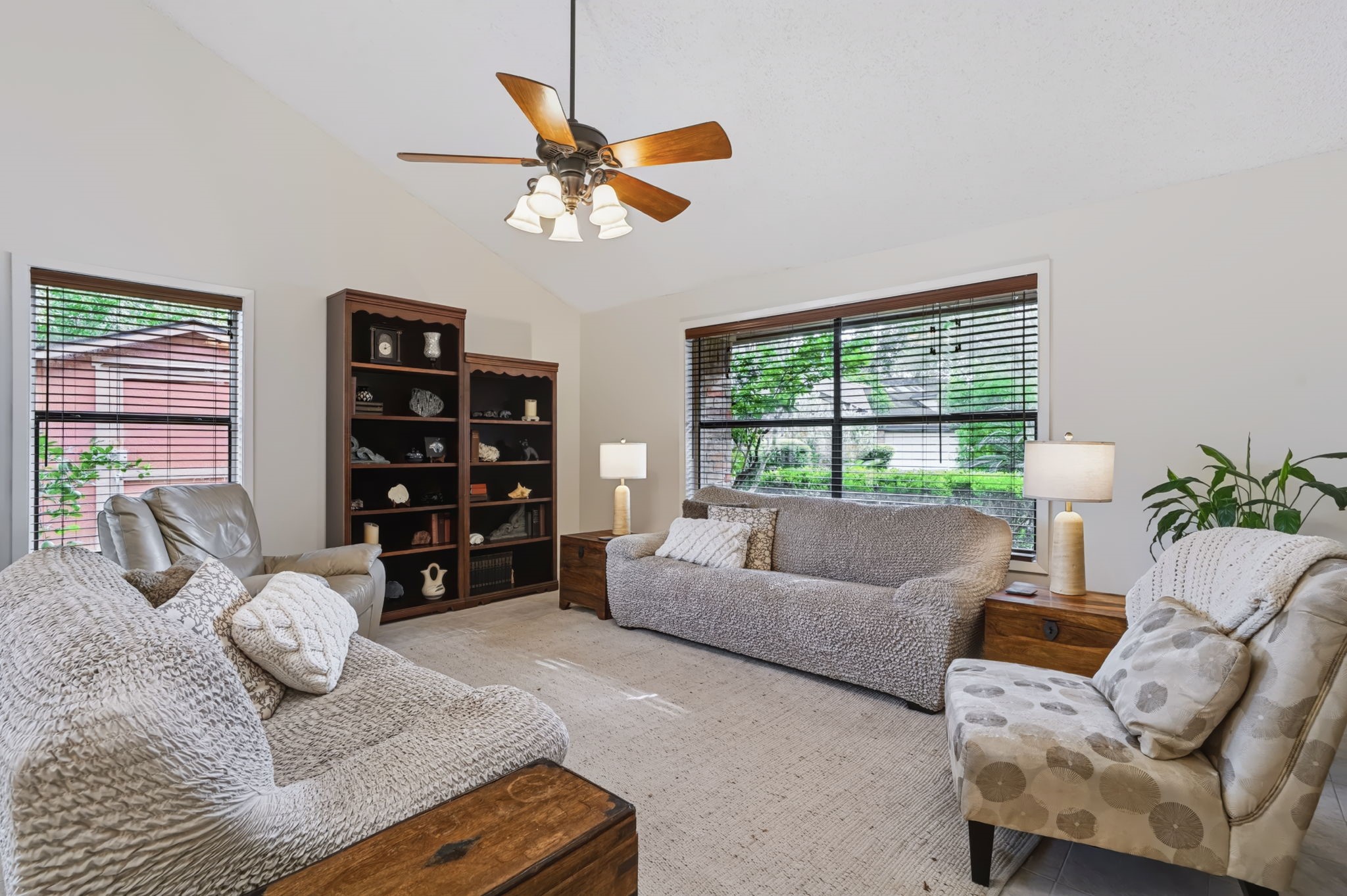 Soaring ceilings and large windows create a bright, open atmosphere in the living room.