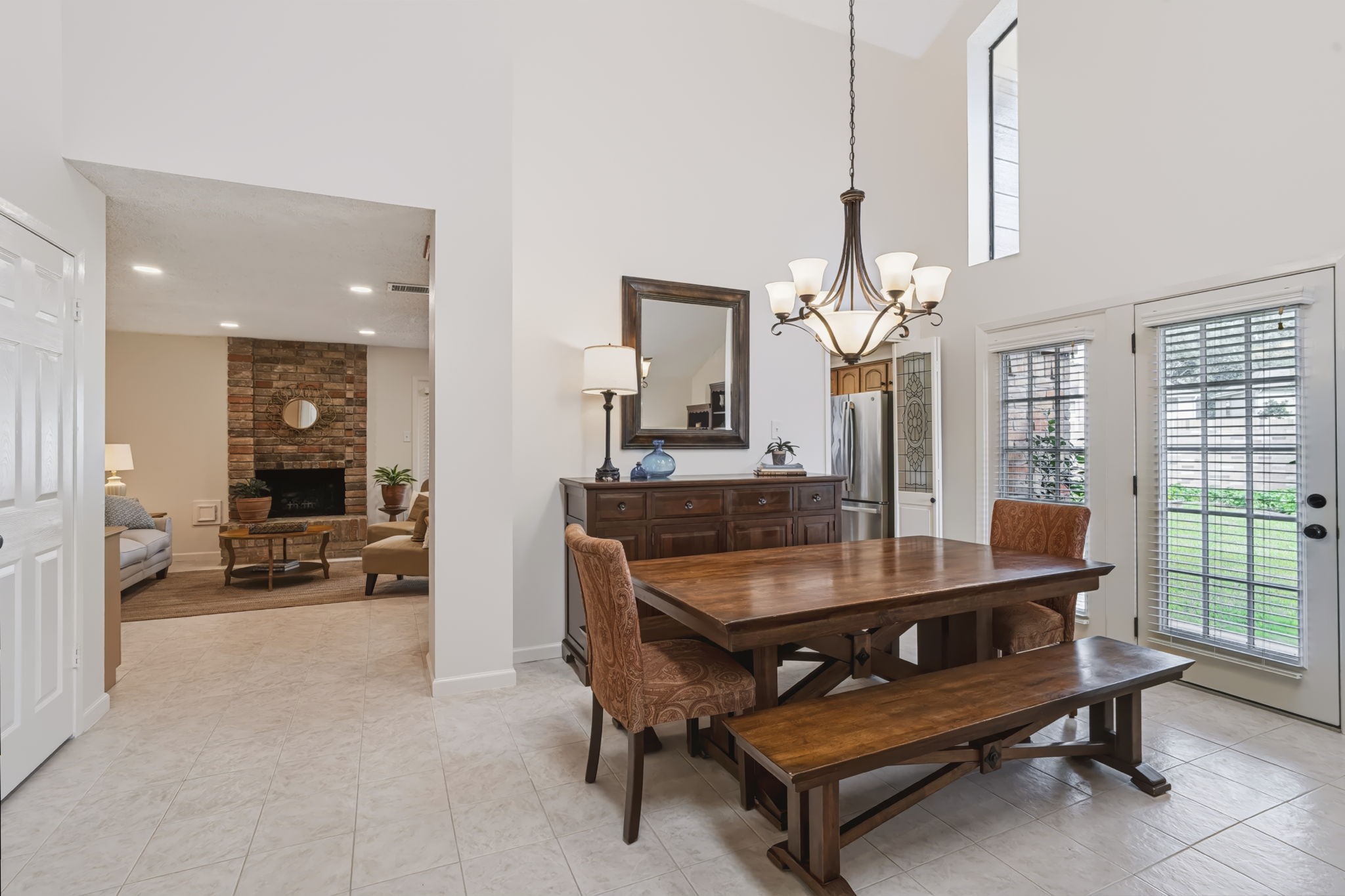 A French door with sidelight opens from the dining room to a side patio, creating a connection to the outdoors and an ideal spot for enjoying fresh air or extending your entertaining space.