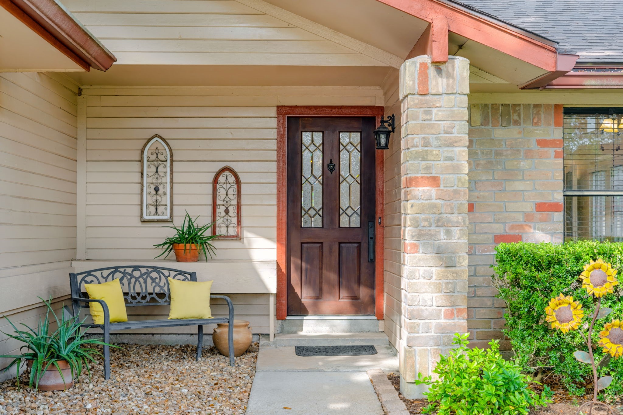 A covered front entrance welcomes you with a beautiful wood and leaded glass front door, creating an inviting first impression with timeless character.