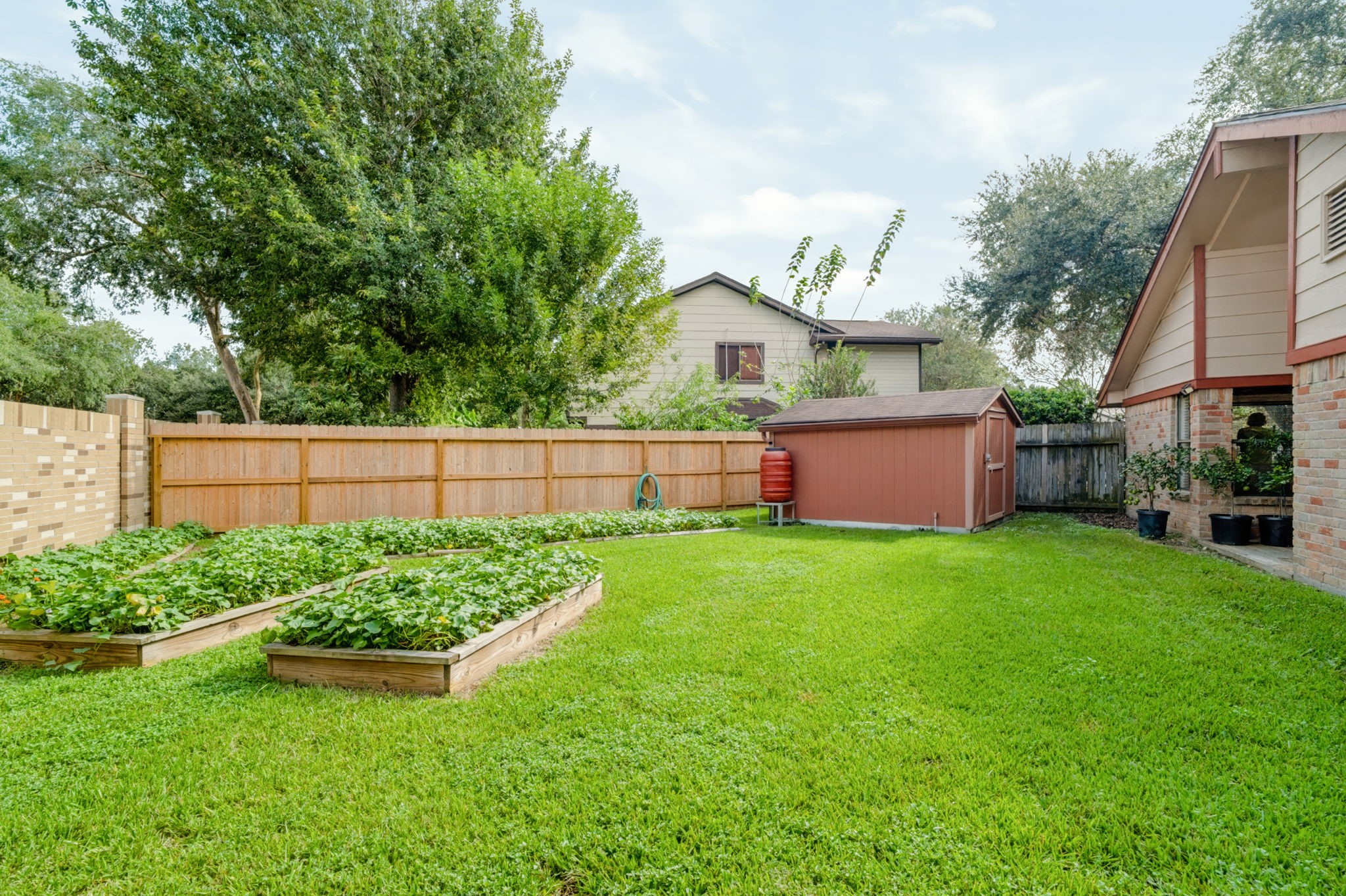 Green-thumb enthusiasts will love the raised garden beds, featuring sweet potatoes ready to harvest and included with the sale!