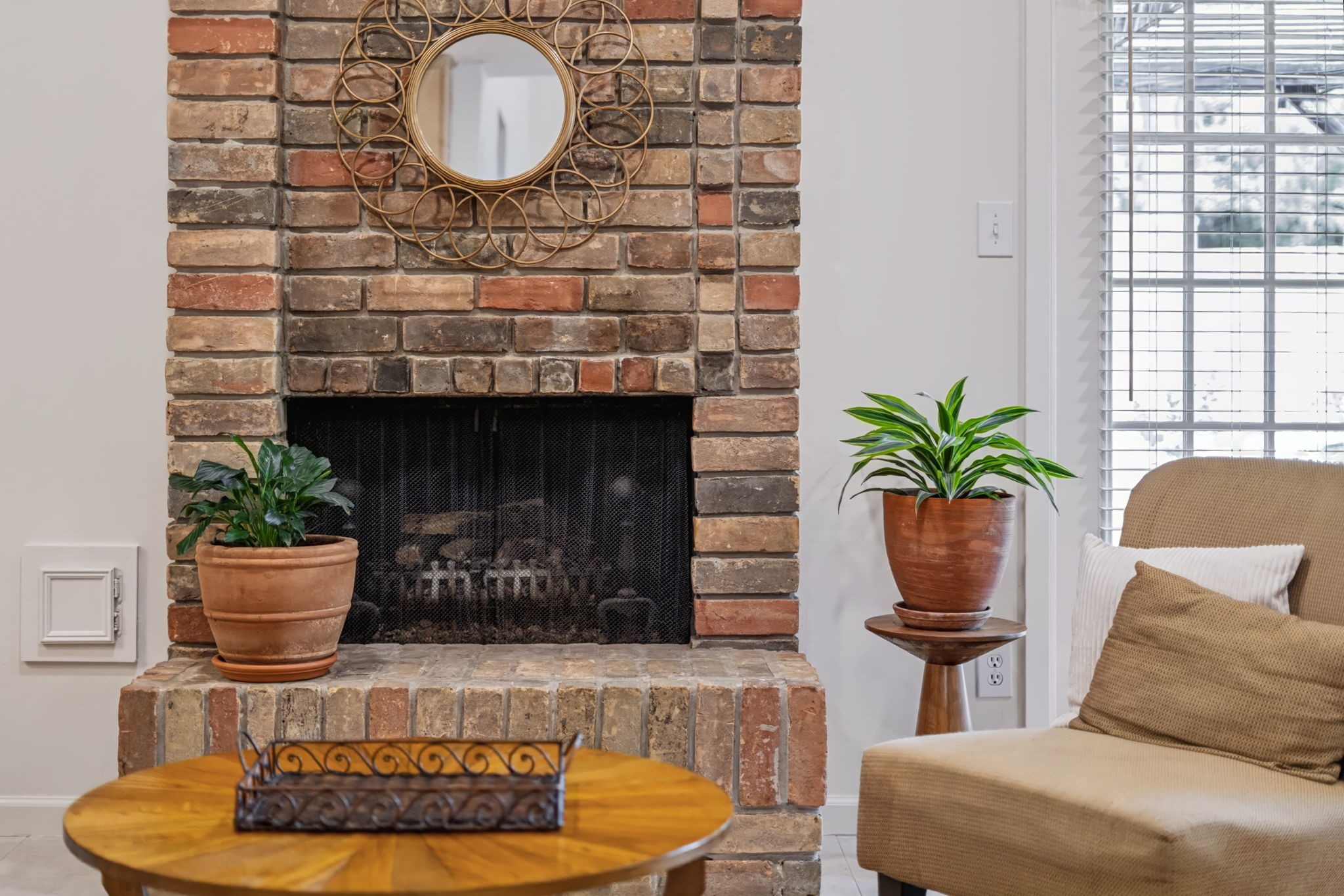 A heartwarming, gas-log brick fireplace creates a cozy focal point, perfect for relaxing evenings and gathering with family and friends.