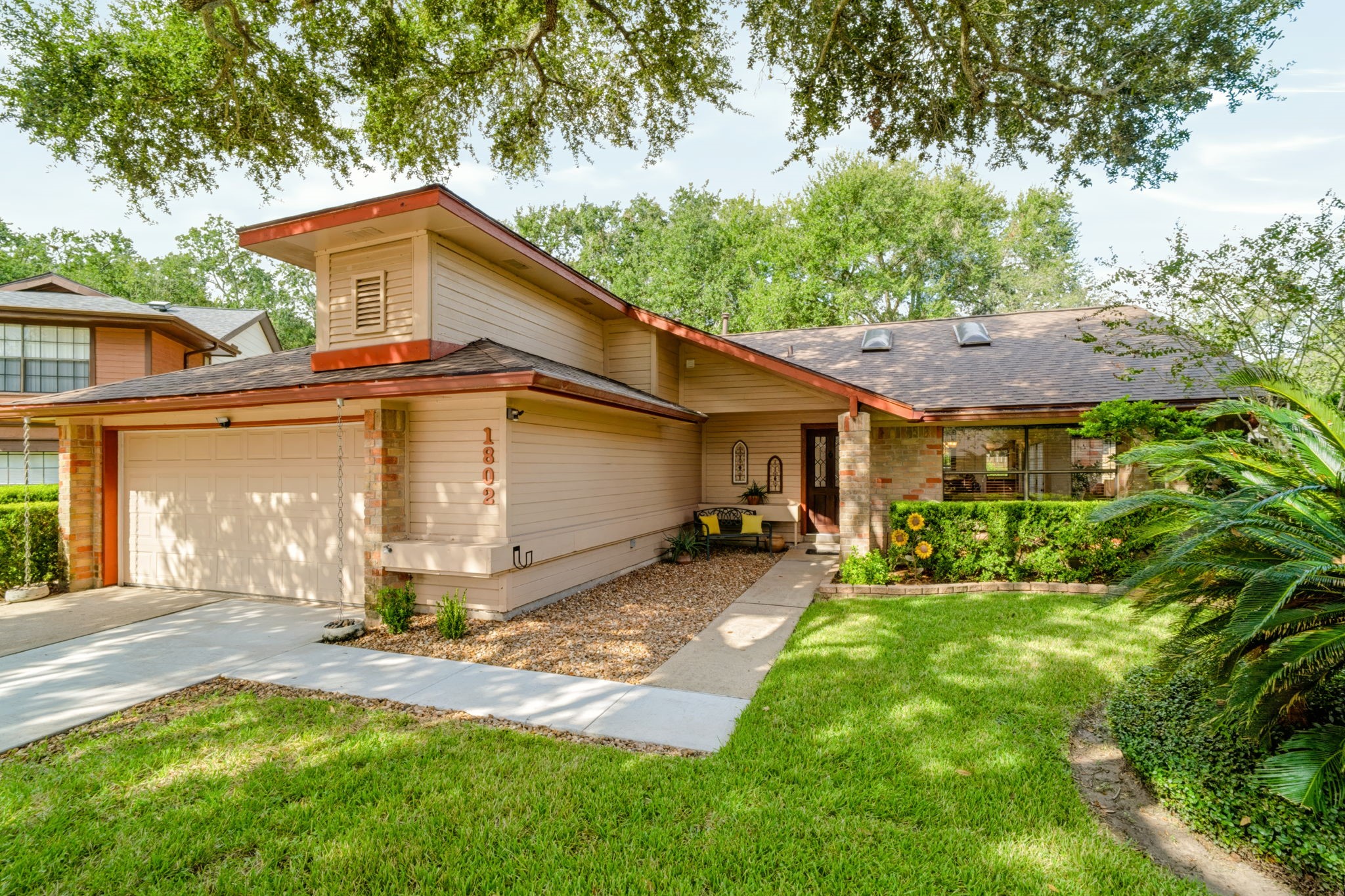 Beautifully maintained front landscaping and a welcoming front porch create inviting curb appeal, reflecting the care and attention given to the property.