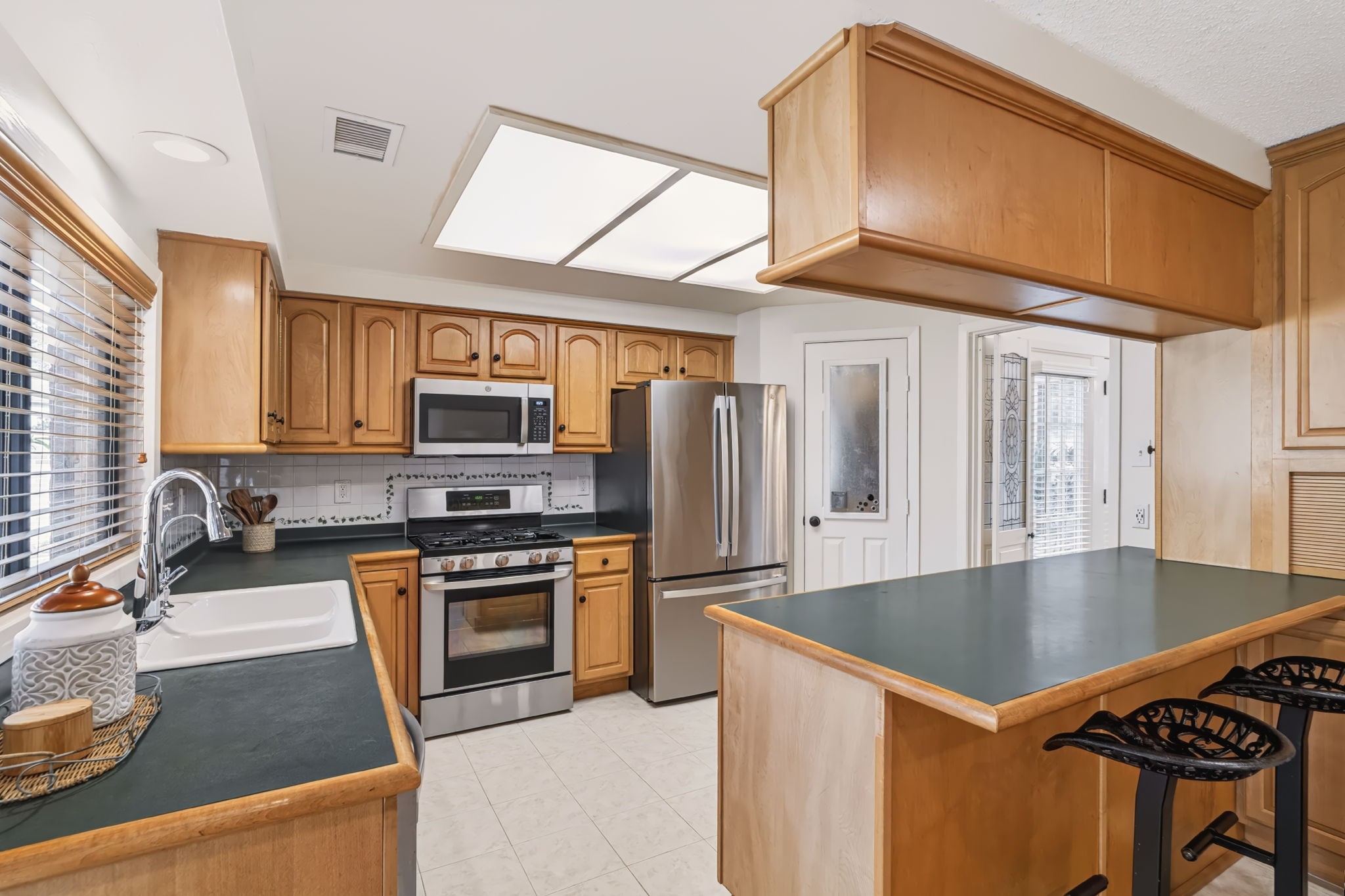 A walk-in pantry tucked beside the refrigerator provides additional storage.