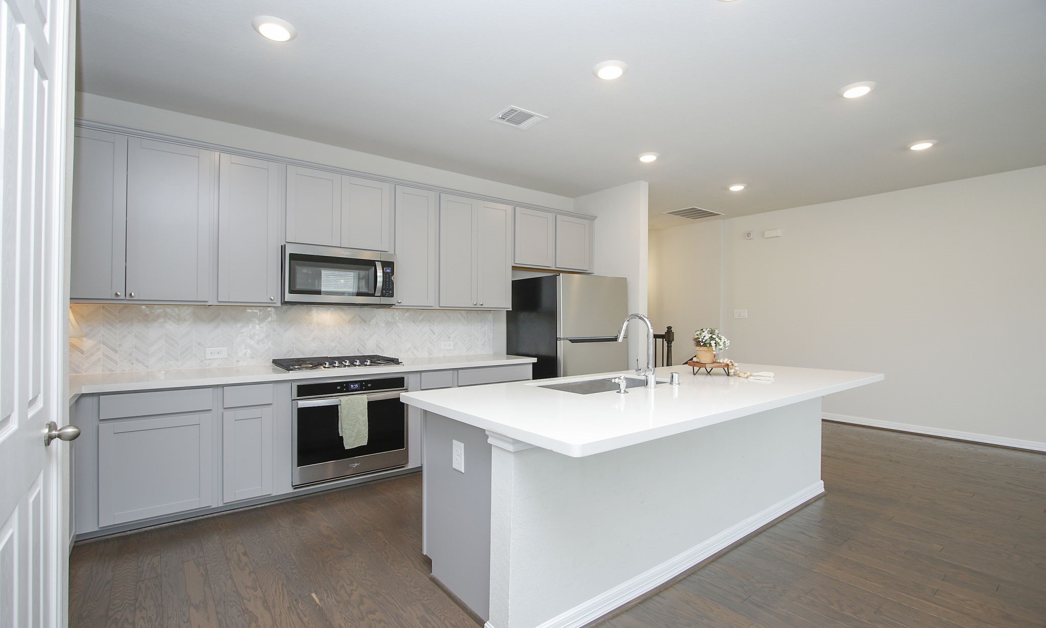 Lovely kitchen with chevron set tile backsplash