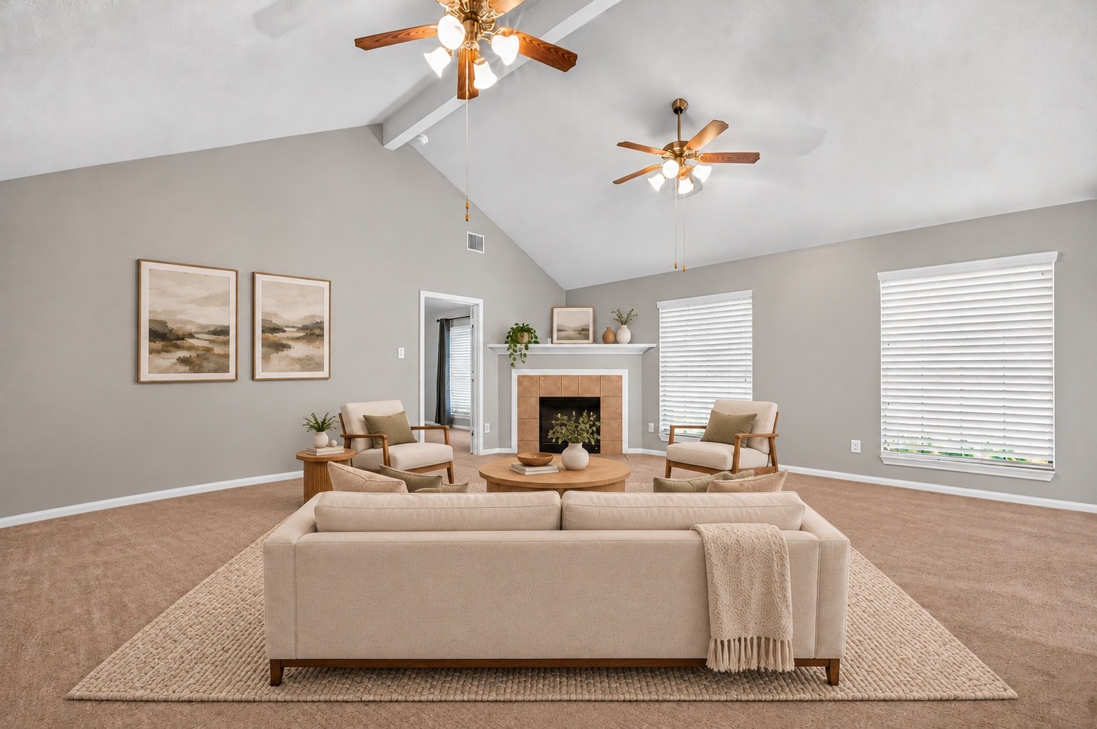 Virtually staged living area featuring a vaulted ceiling, two ceiling fans, a tile-surround fireplace, and large windows with white blinds.