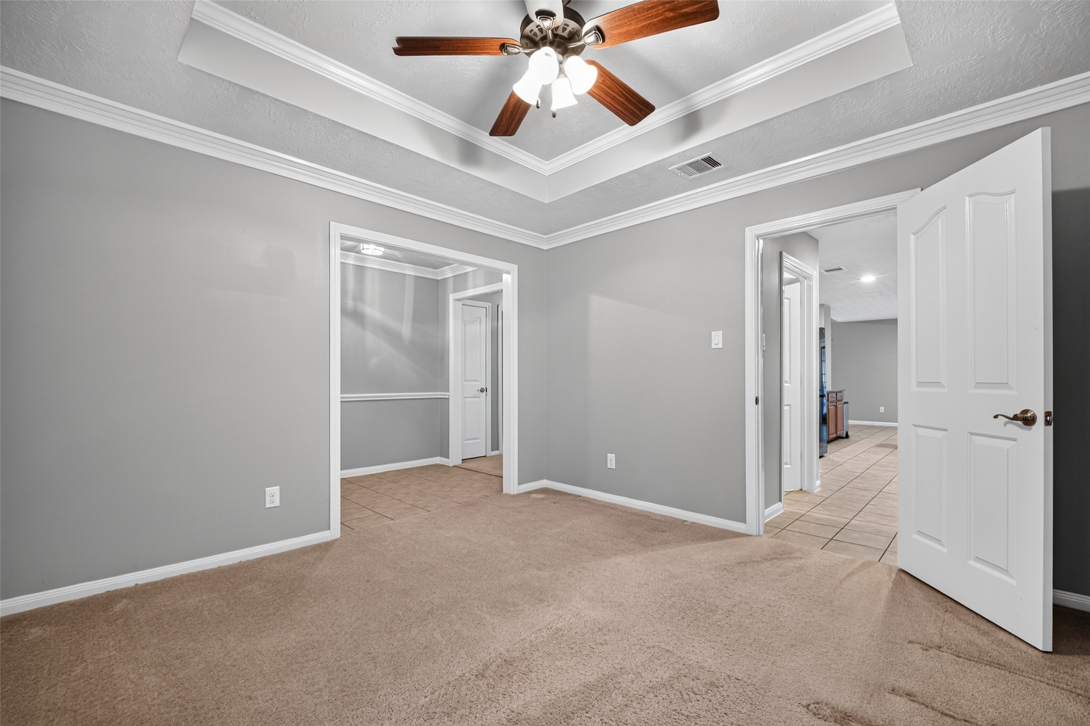 Additional view of the flex space highlighting recessed lighting, detailed ceiling, and open layout.