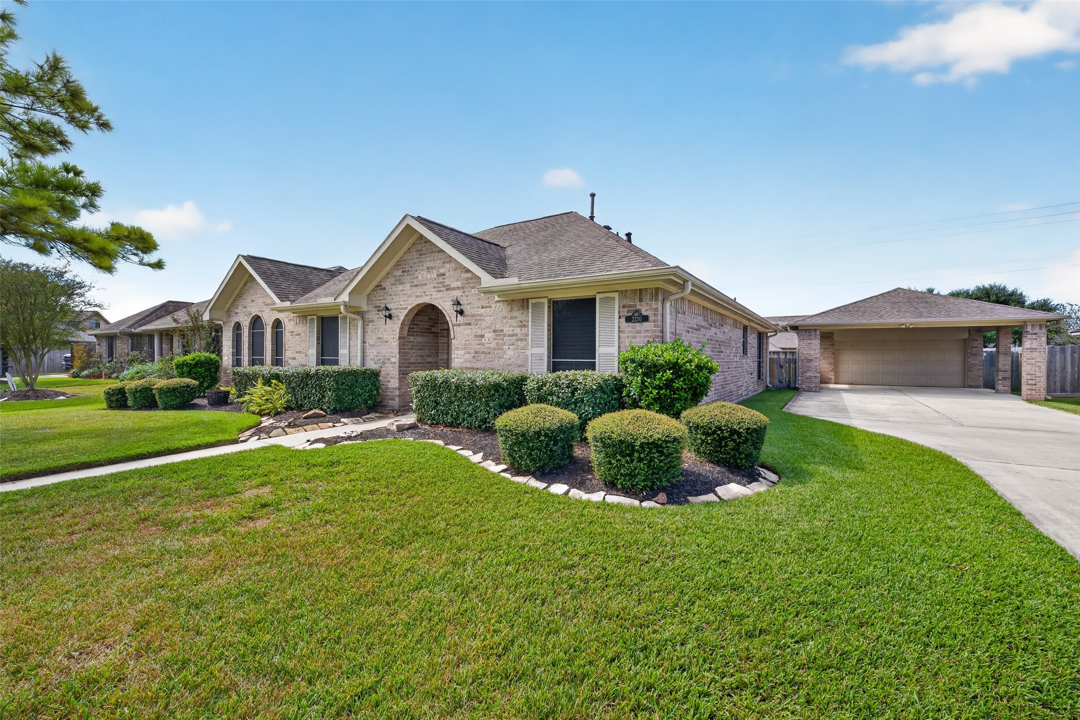 Angled exterior view showcases the homes brick facade, multiple roof gables, decorative shutters, and established landscaping along the front elevation. Angled exterior view showcases the homes brick facade, multiple roof gables, decorative shutters, and established landscaping along the front elevation.