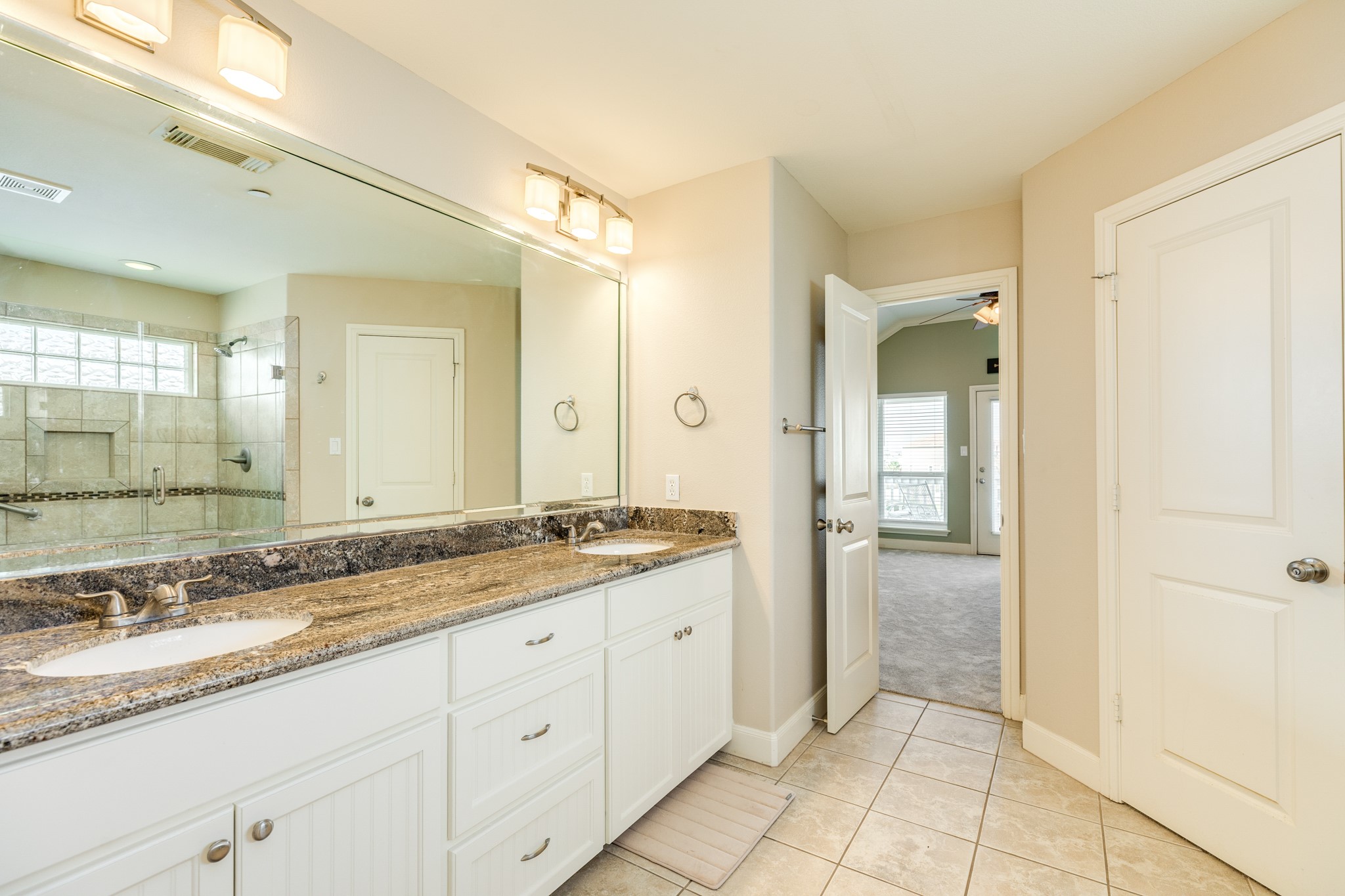 Primary bath has double vanity sinks, water closet, his & her closets and a walk in shower.