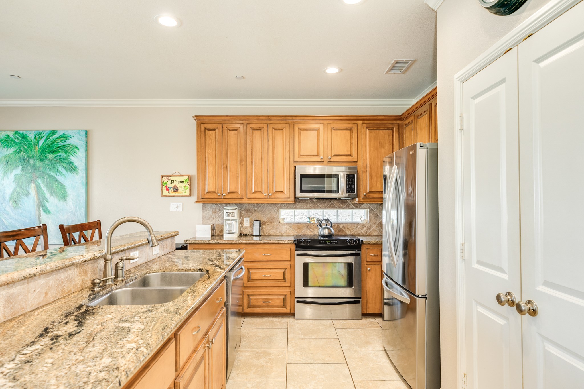 Counter tops are granite, double stainless sinks, stainless steel appliances and solid wood cabinets offered in this home.