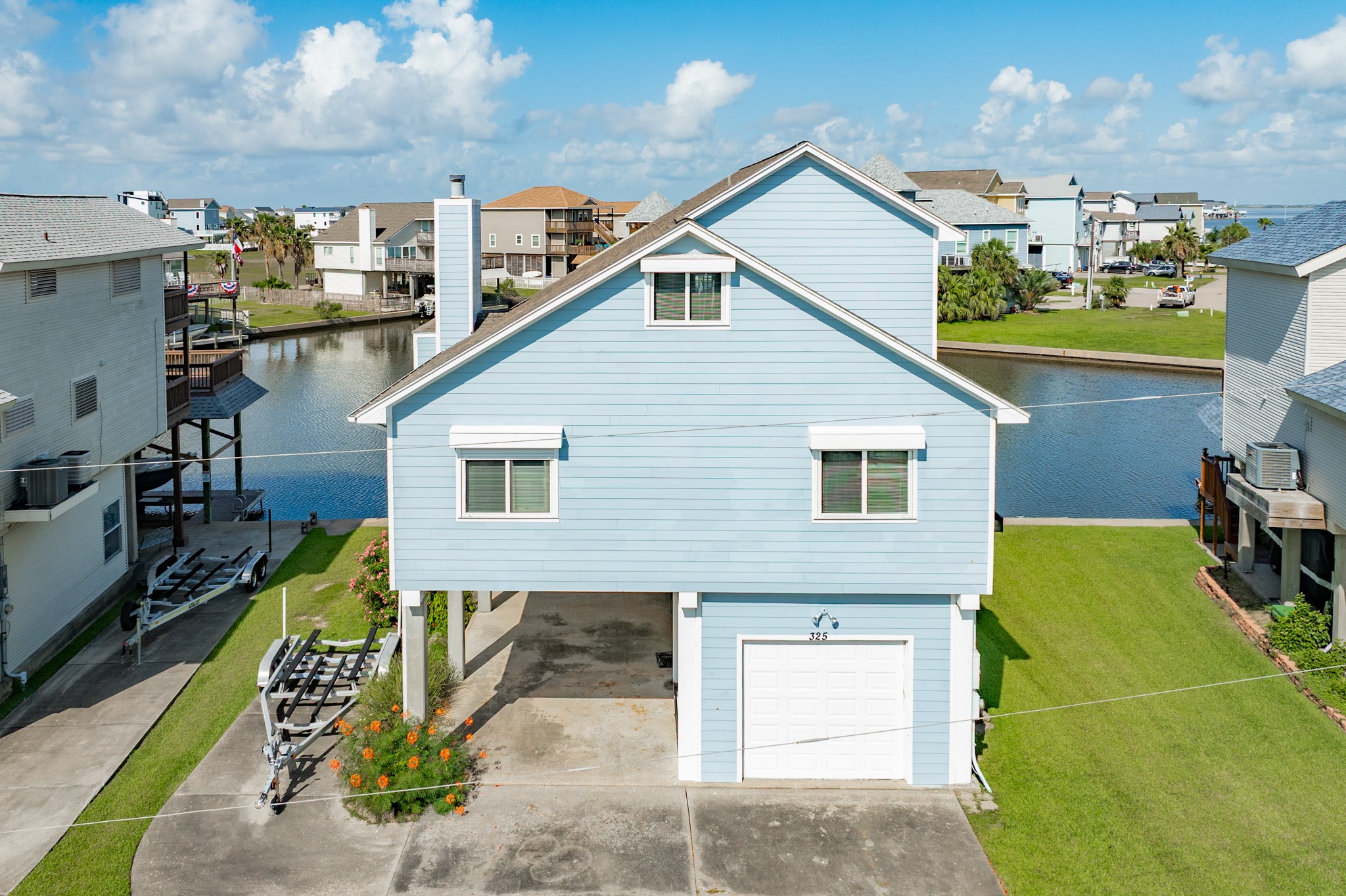 Property has a double wide driveway, parking under home, 1 car garage and as a bonus, concrete pad to park your boat trailer.