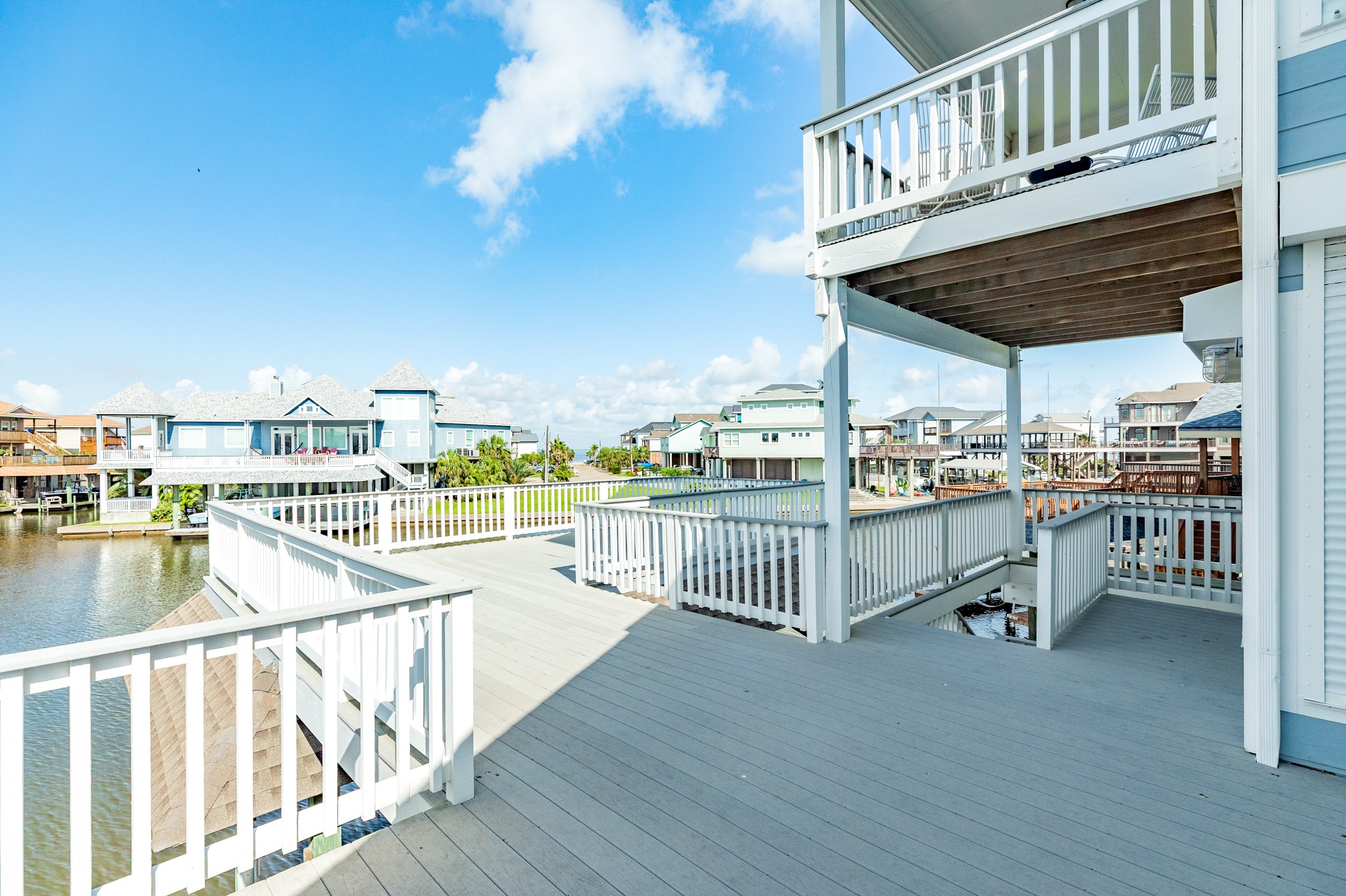Main deck provides over 500 sq ft of entertaining space and views of the bay and canals.