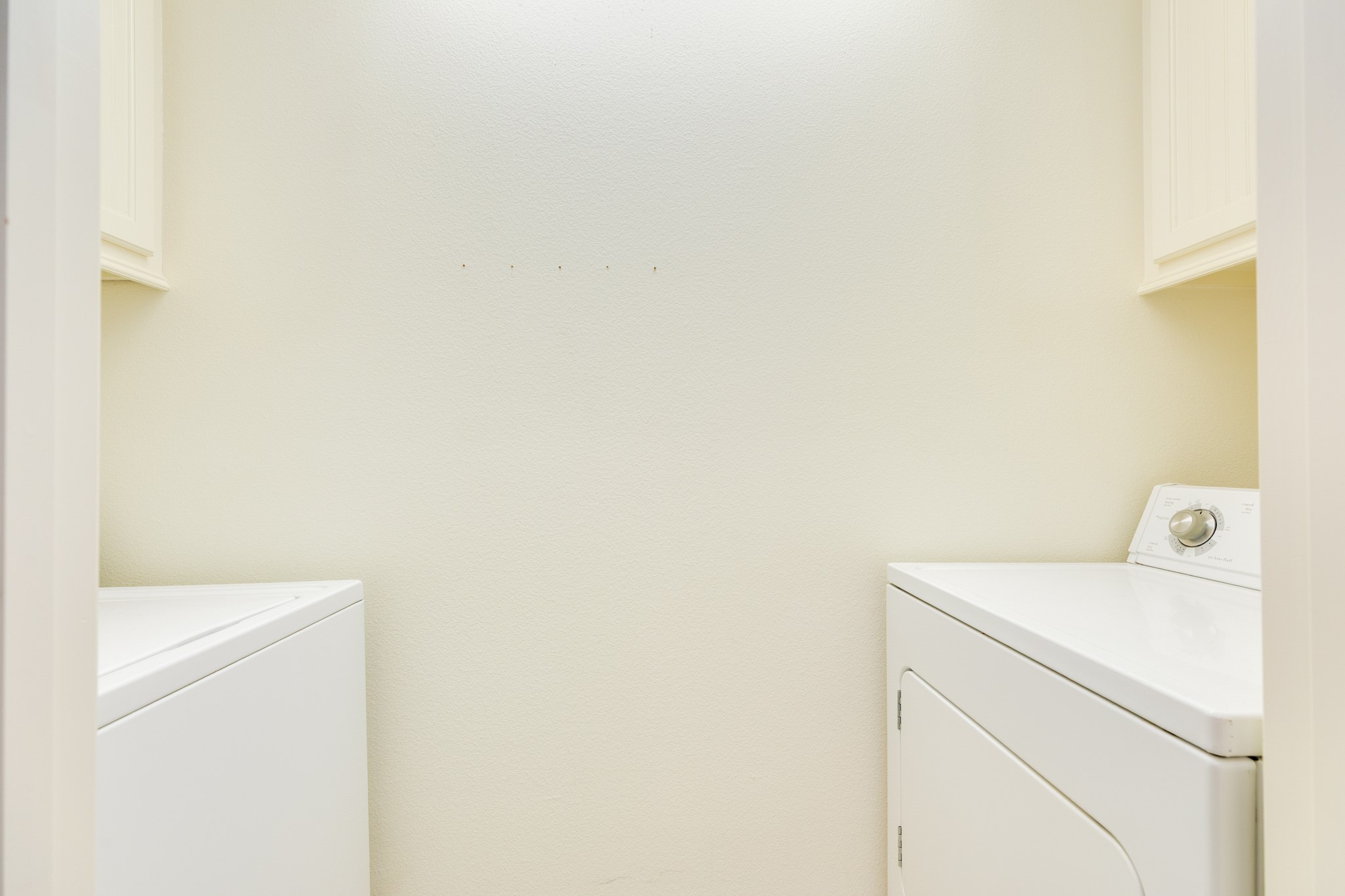Utility closet with electric Clothes Washing & drying machines.