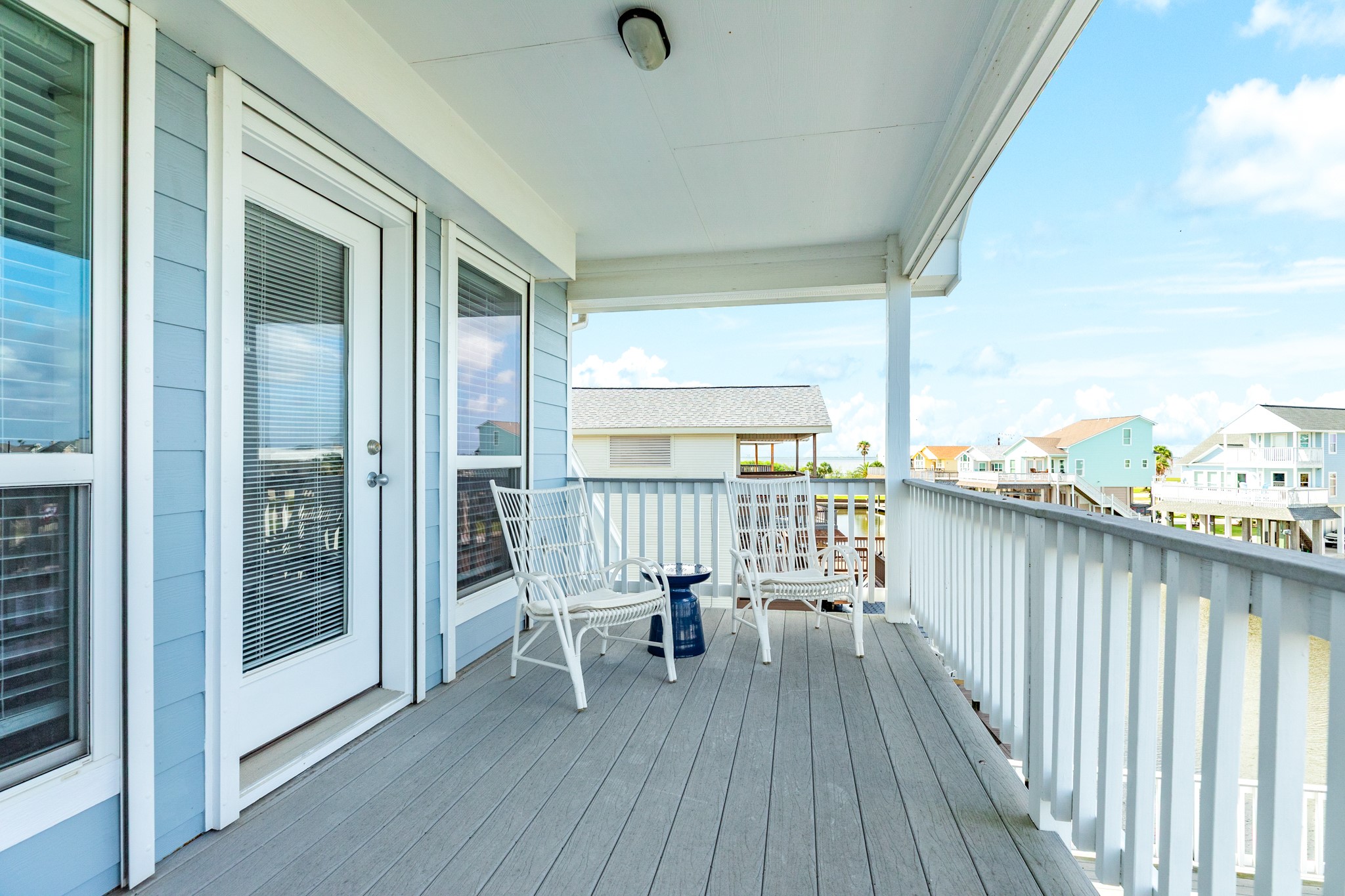 The private deck outside of the primary suite is covered and ideal for watching the sunsets over the bay.