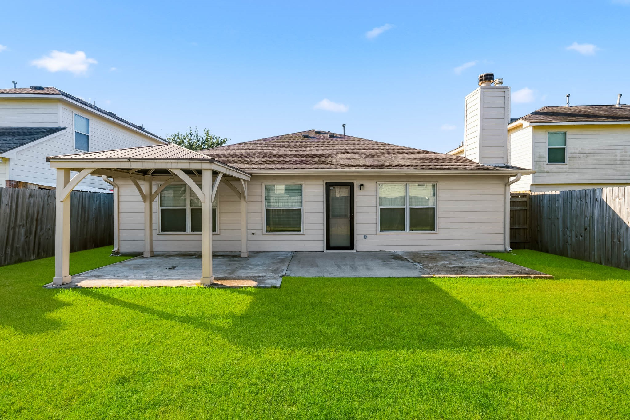 Generously sized fenced backyard with plenty of room to relax, play, or entertain.
