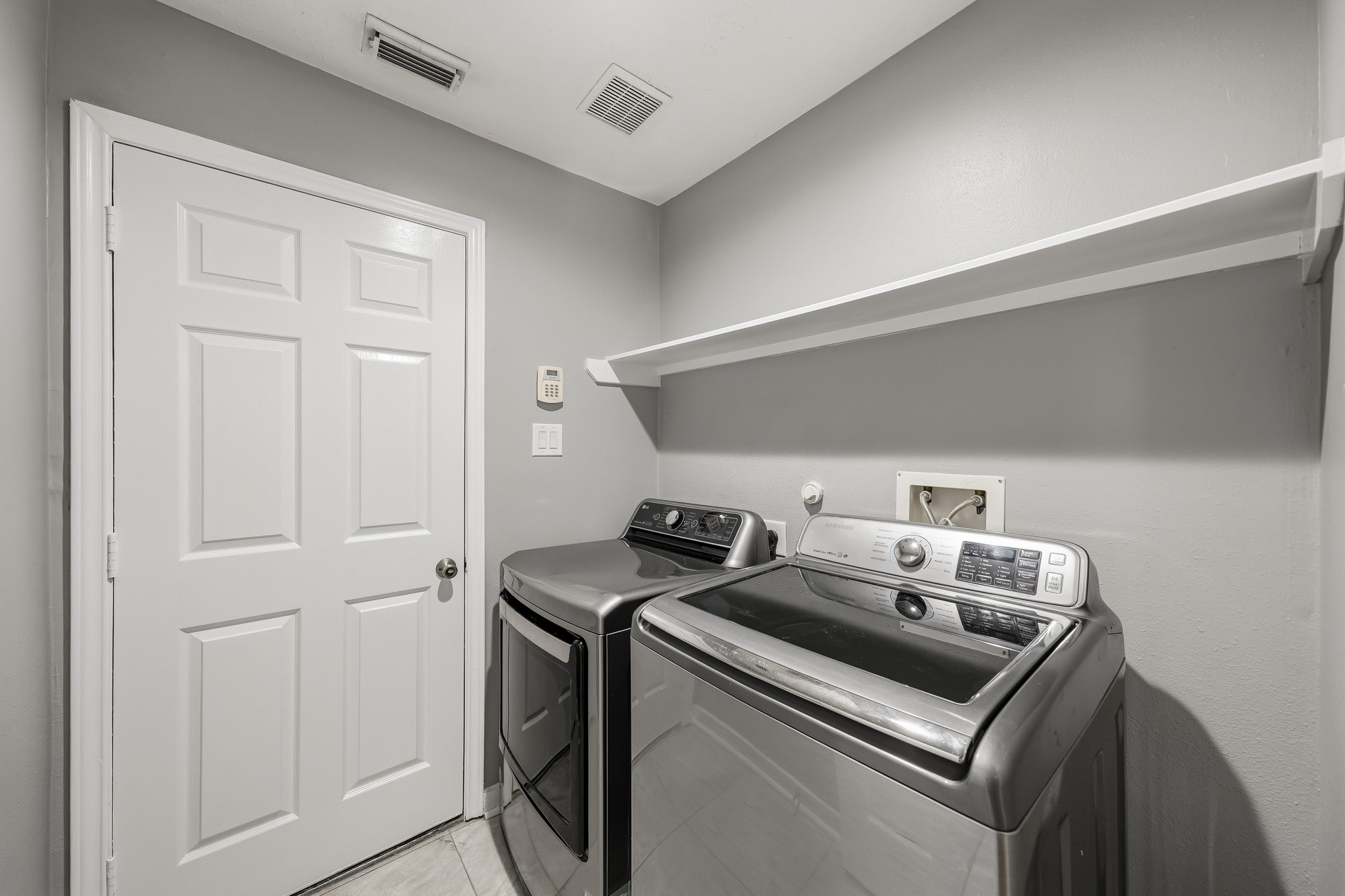 Dedicated indoor utility room offers convenient laundry space and additional storage.