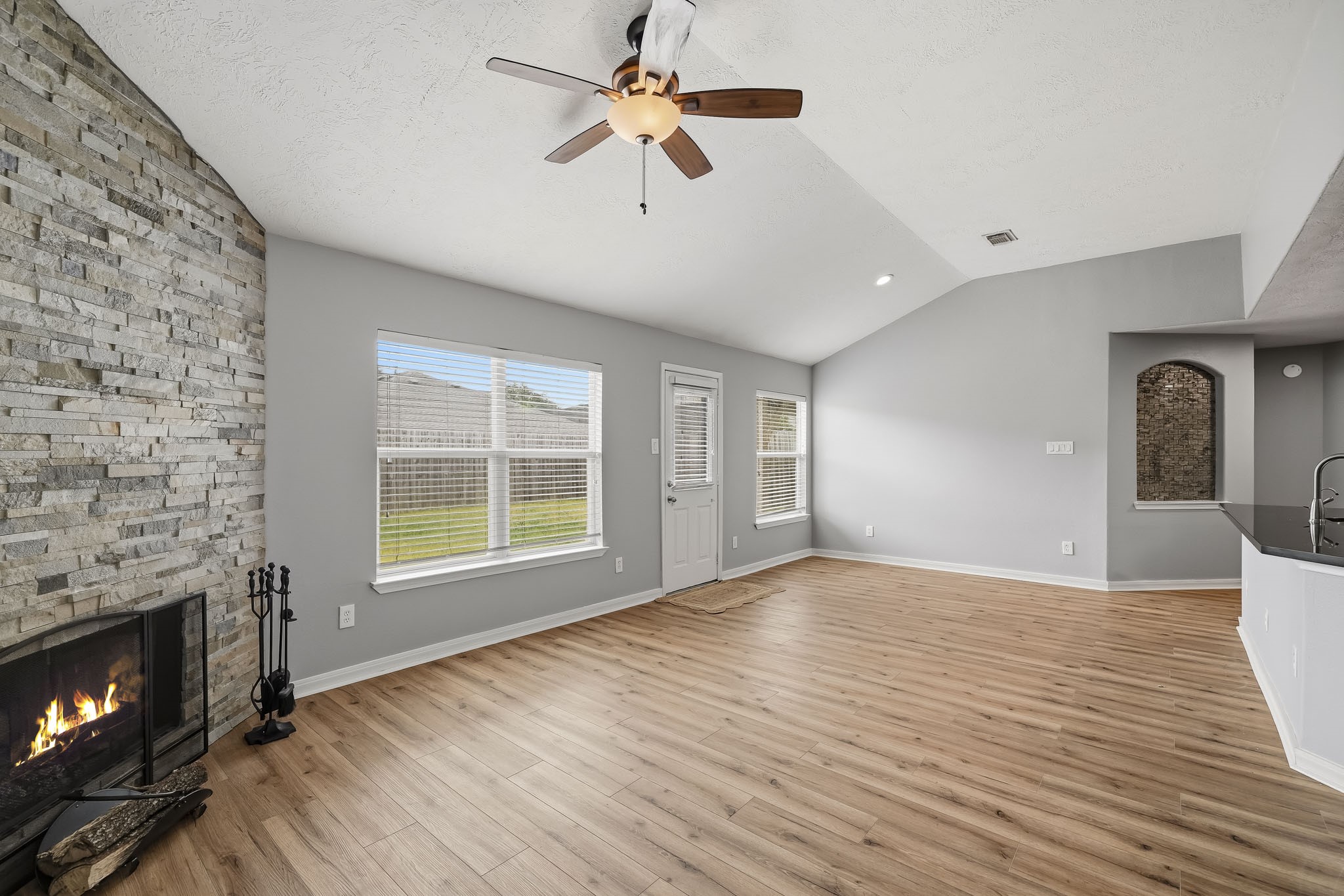 Generously sized family area offers flexible furniture placement and an easy flow into the adjoining spaces.