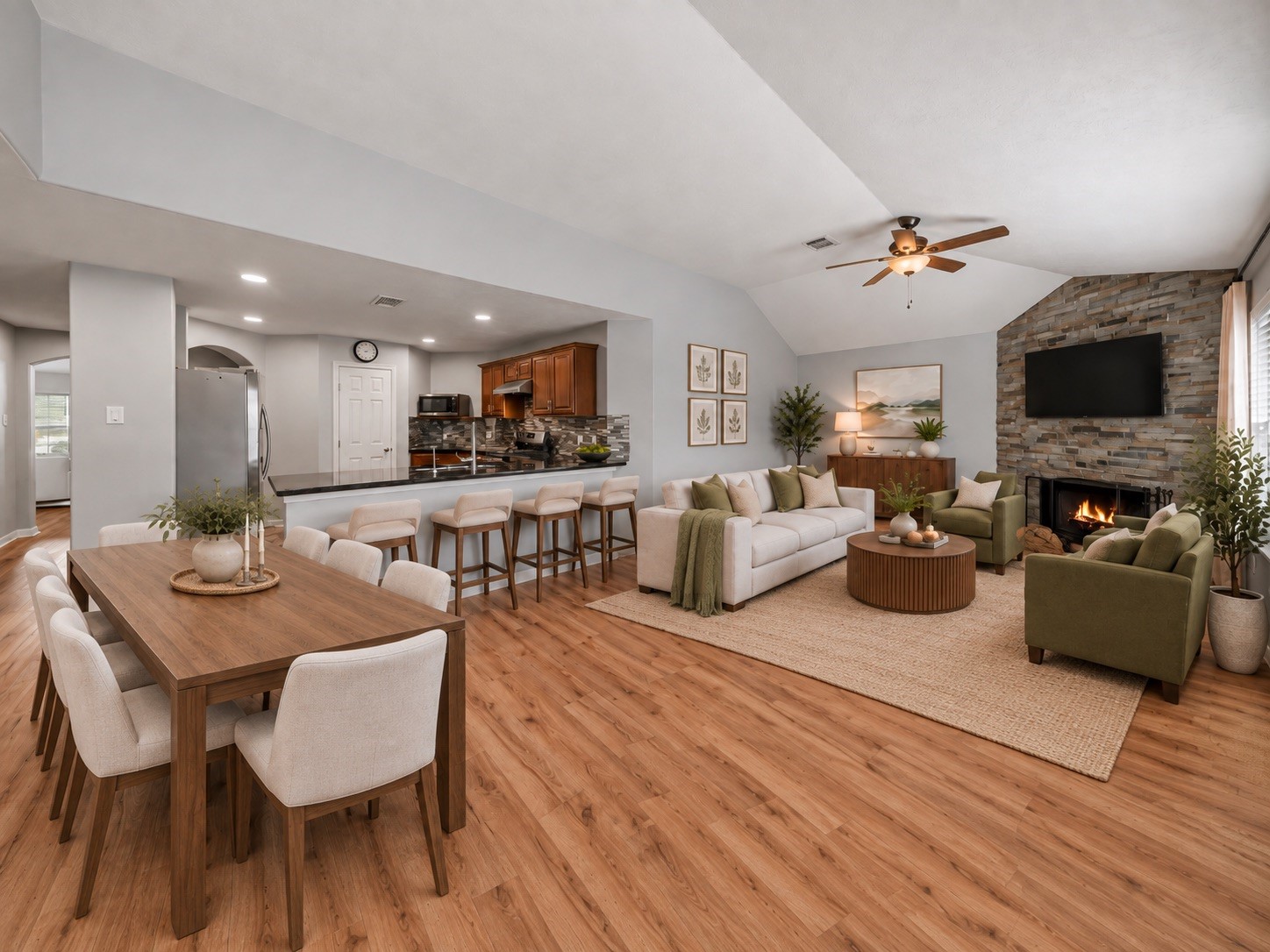 Virtually staged space demonstrates the easy flow between the kitchen, dining area, and family area.