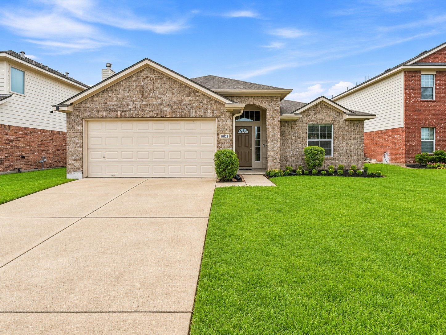 Wide driveway provides convenient access to the attached two-car garage.