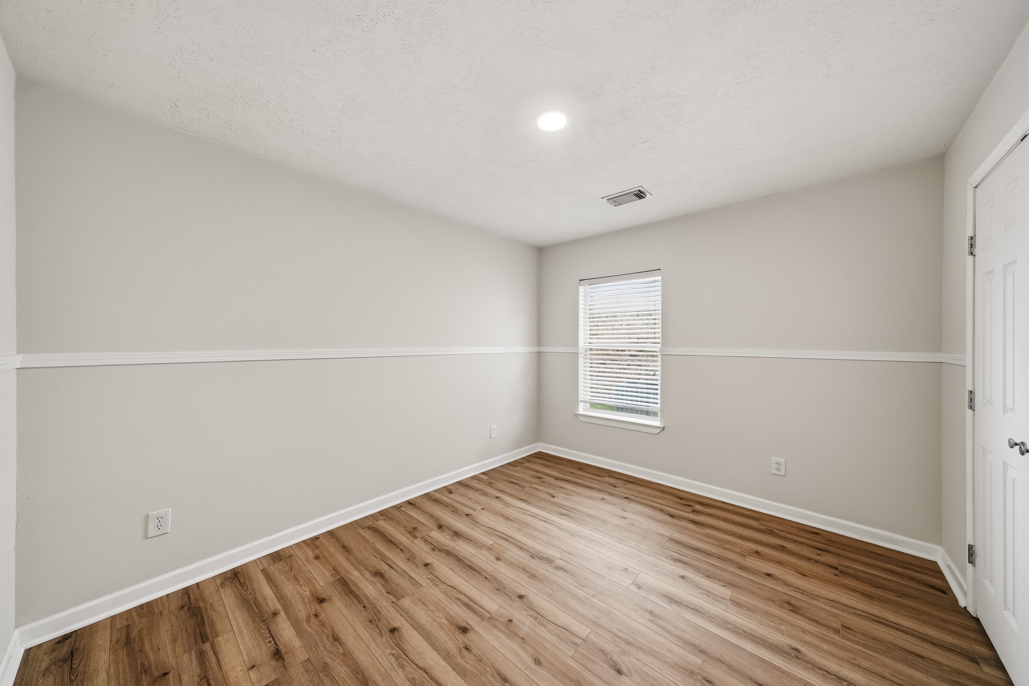 Spacious secondary bedroom provides flexibility for guests, family, or a home office.