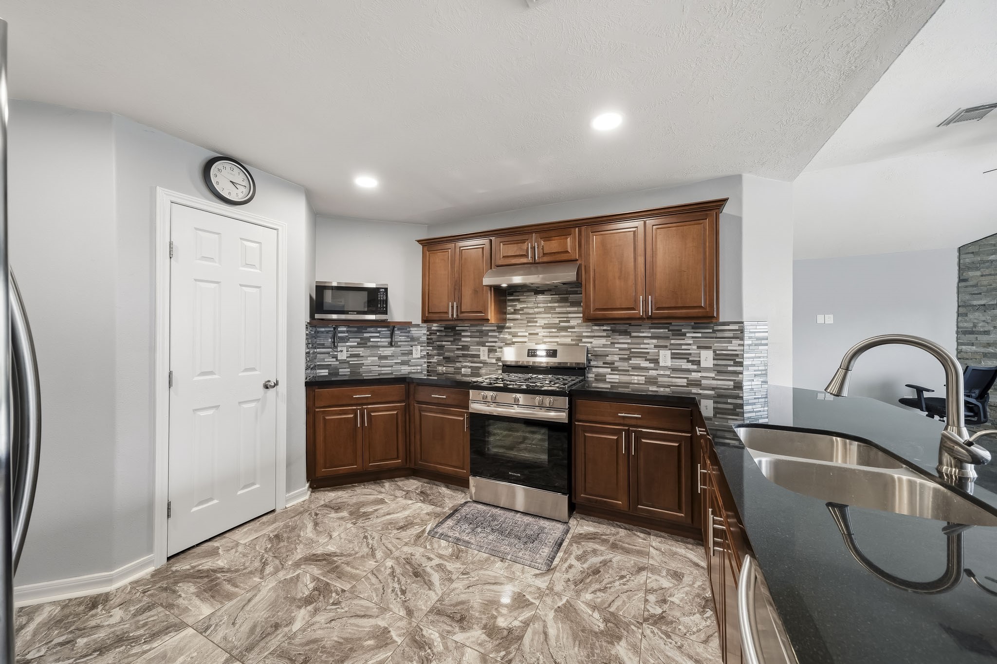 Functional kitchen layout includes plentiful storage and an open connection to the adjoining family area.