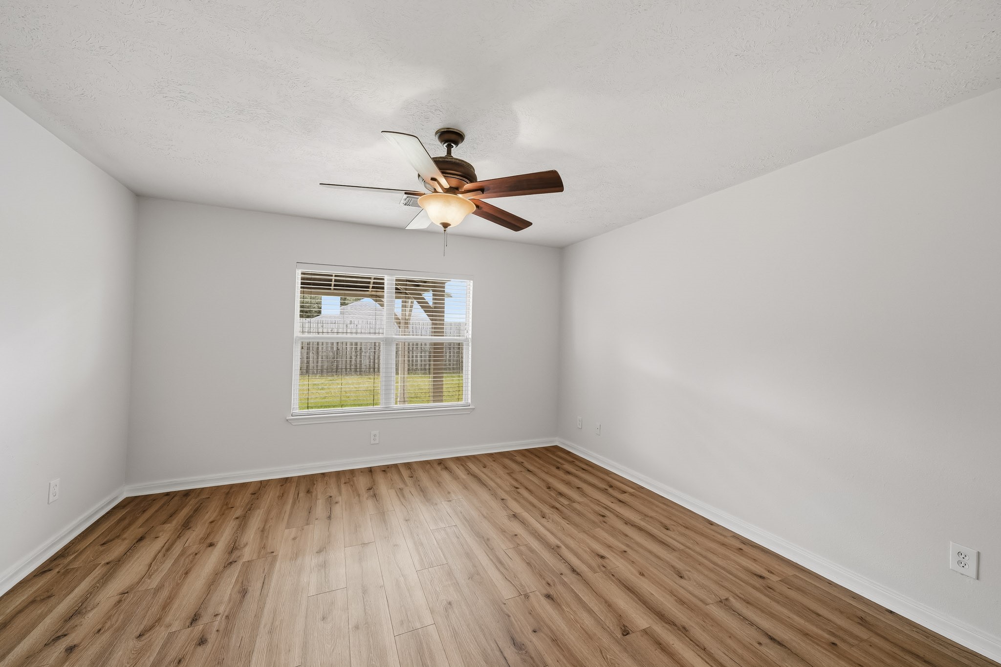 Primary suite offers a comfortable footprint with room for multiple furniture arrangements.
