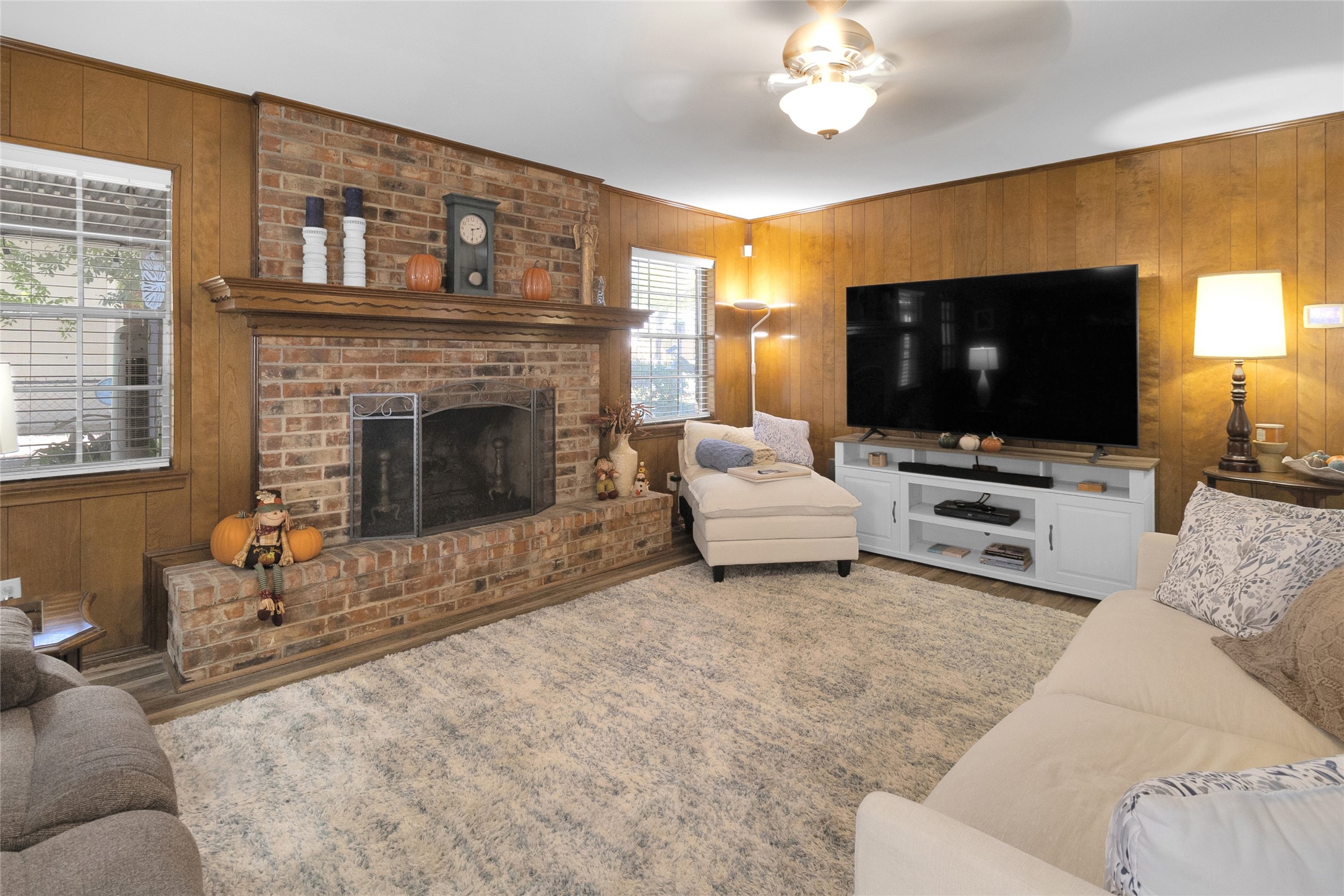 Cozy living room featuring a charming brick fireplace. Cozy living room featuring a charming brick fireplace.