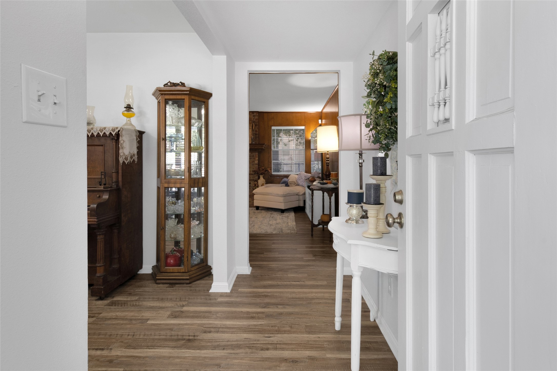 Charming entryway with elegant wood flooring leads to a cozy living area. Charming entryway with elegant wood flooring leads to a cozy living area.