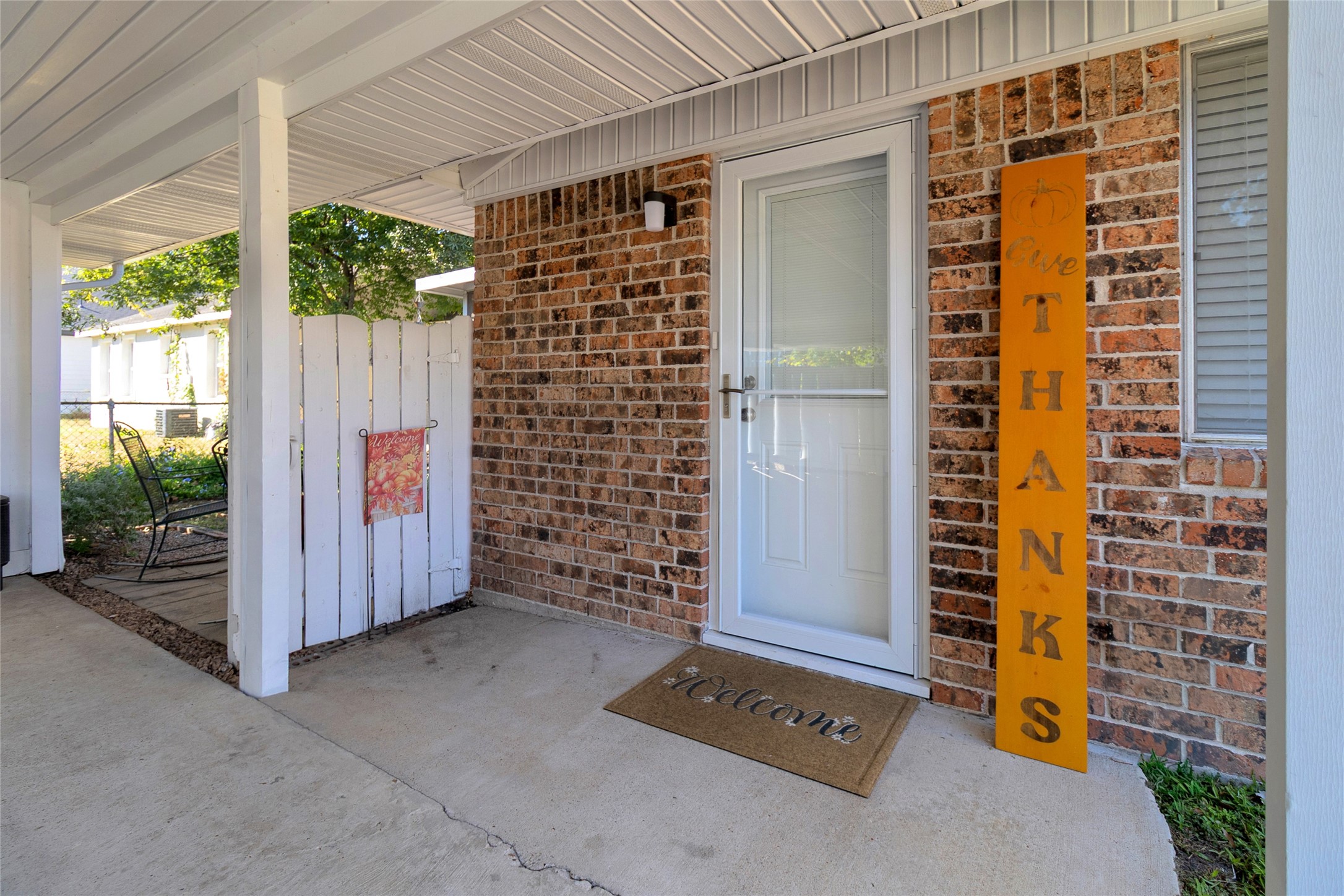 Charming entrance with a welcoming front door, cozy seating area, and decorative accents, perfect for greeting guests.