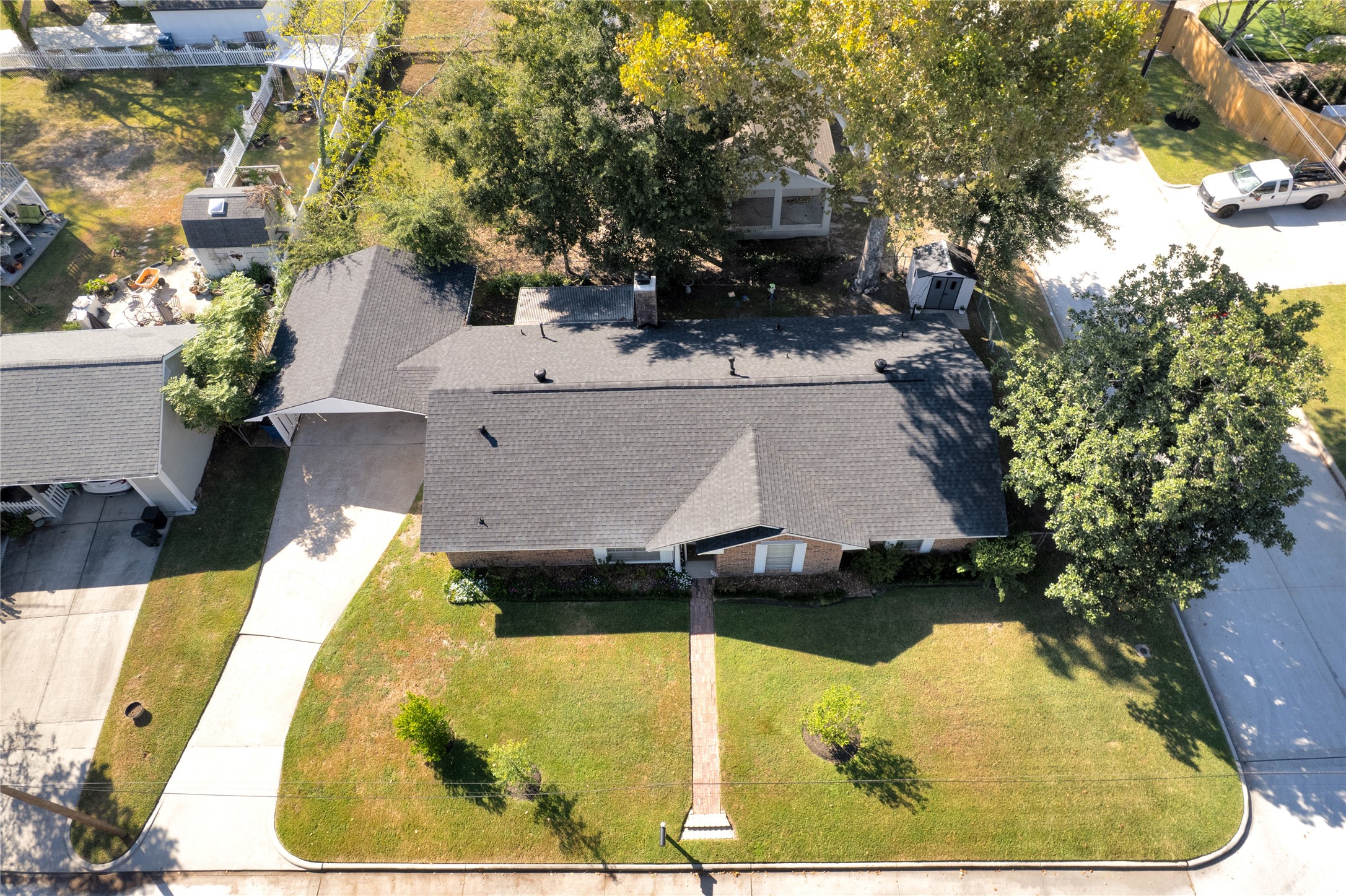 Charming single-story home with a well-maintained lawn, mature trees, and a welcoming walkway leading to the entrance. The property features a spacious driveway and a cozy backyard space, perfect for outdoor enjoyment.