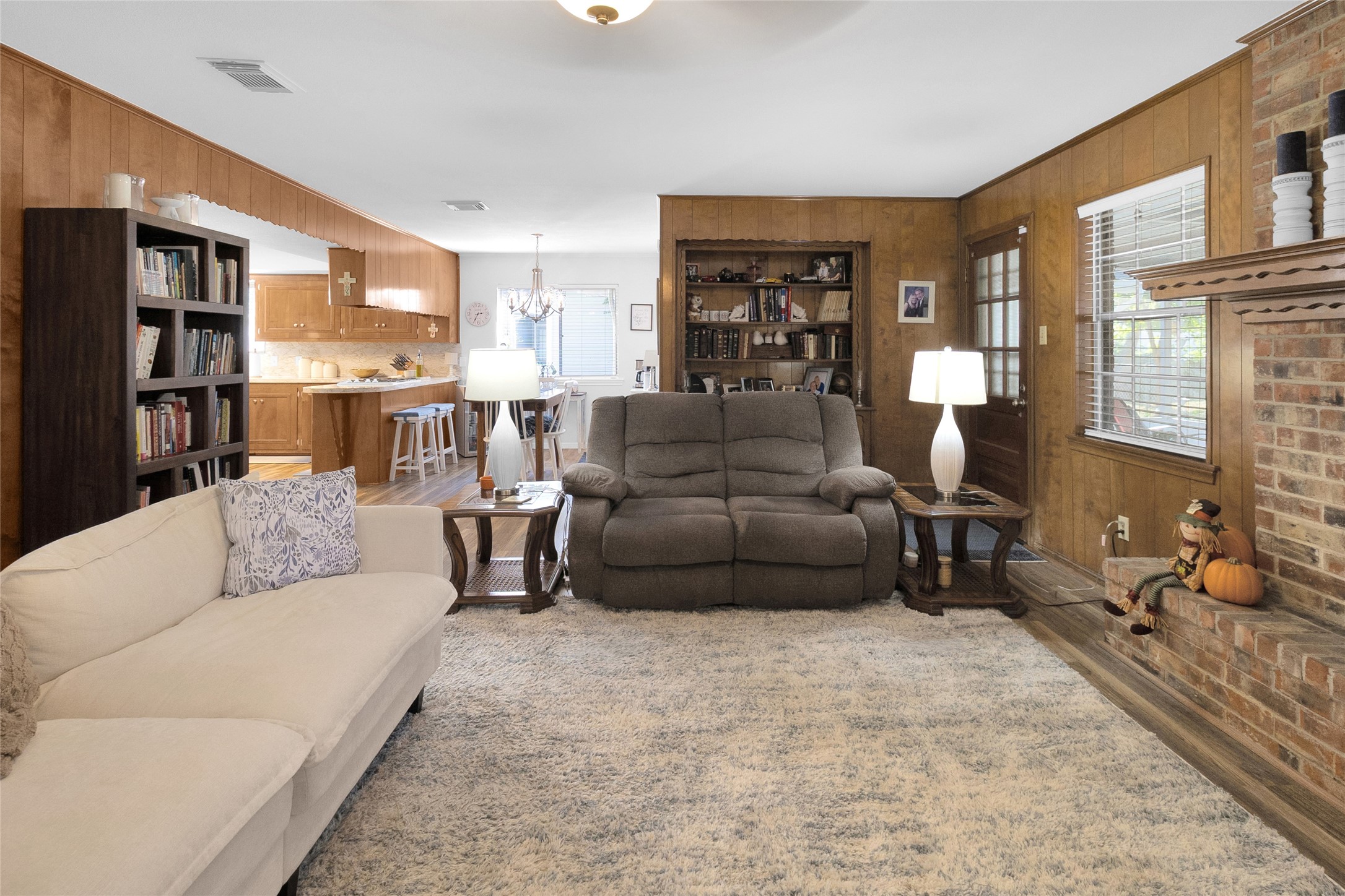 View from the spacious living room looking into the kitchen and breakfast area, highlighting the home's inviting and functional layout.