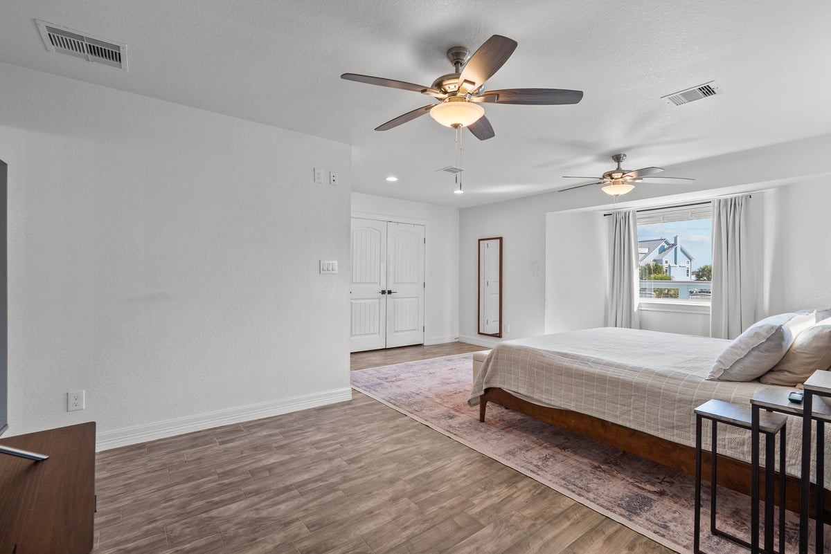 This Primary Bedroom offers ample space perfect blend of Comfort and Coastal Style.