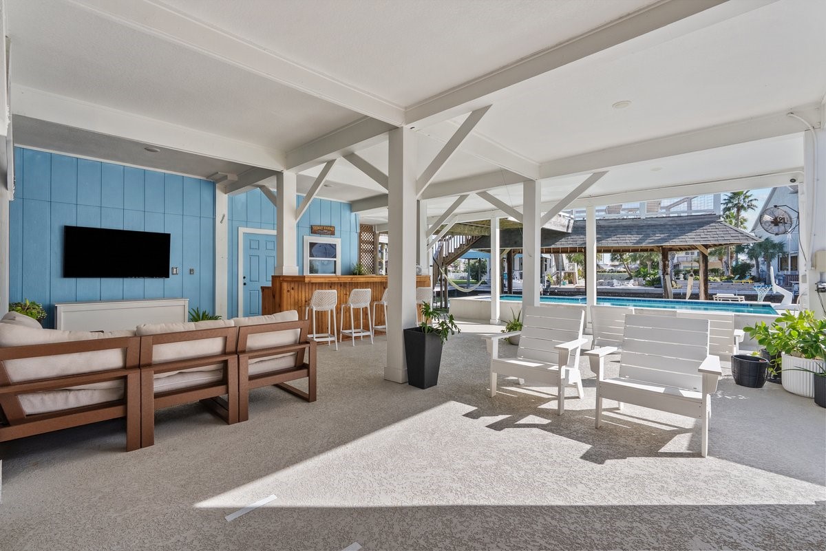 Ultimate Backyard Oasis! Features a custom in-ground pool, expansive shaded patio area, direct canal/water access, private boat lift and dock, providing the perfect setup for boaters and water sport enthusiasts!