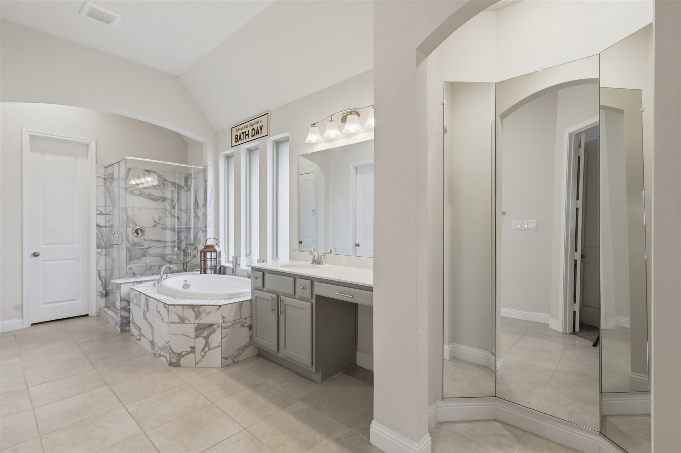 Dual vanities, soaking tub, and elegant finishes in the primary bath.