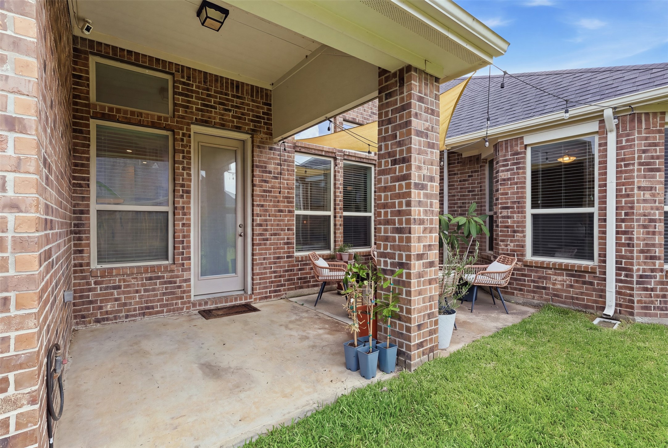 Covered back patio perfect for outdoor dining and relaxing.