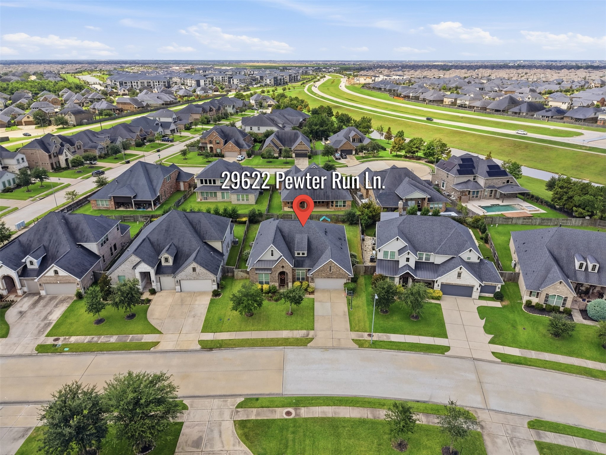 Aerial view showcasing the home's spacious lot and surrounding neighborhood.