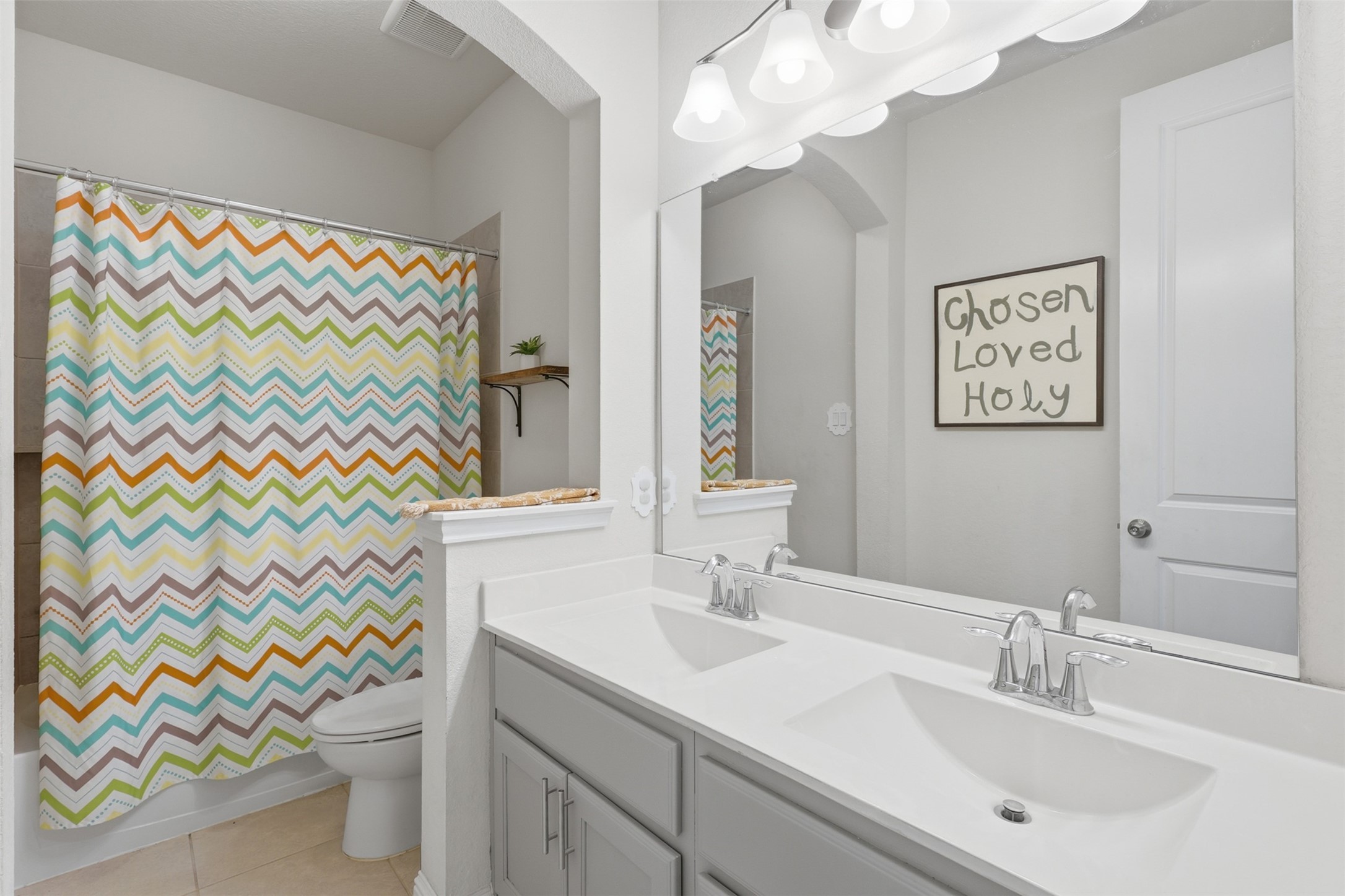 Secondary full bathroom with vanity and tub/shower combination.