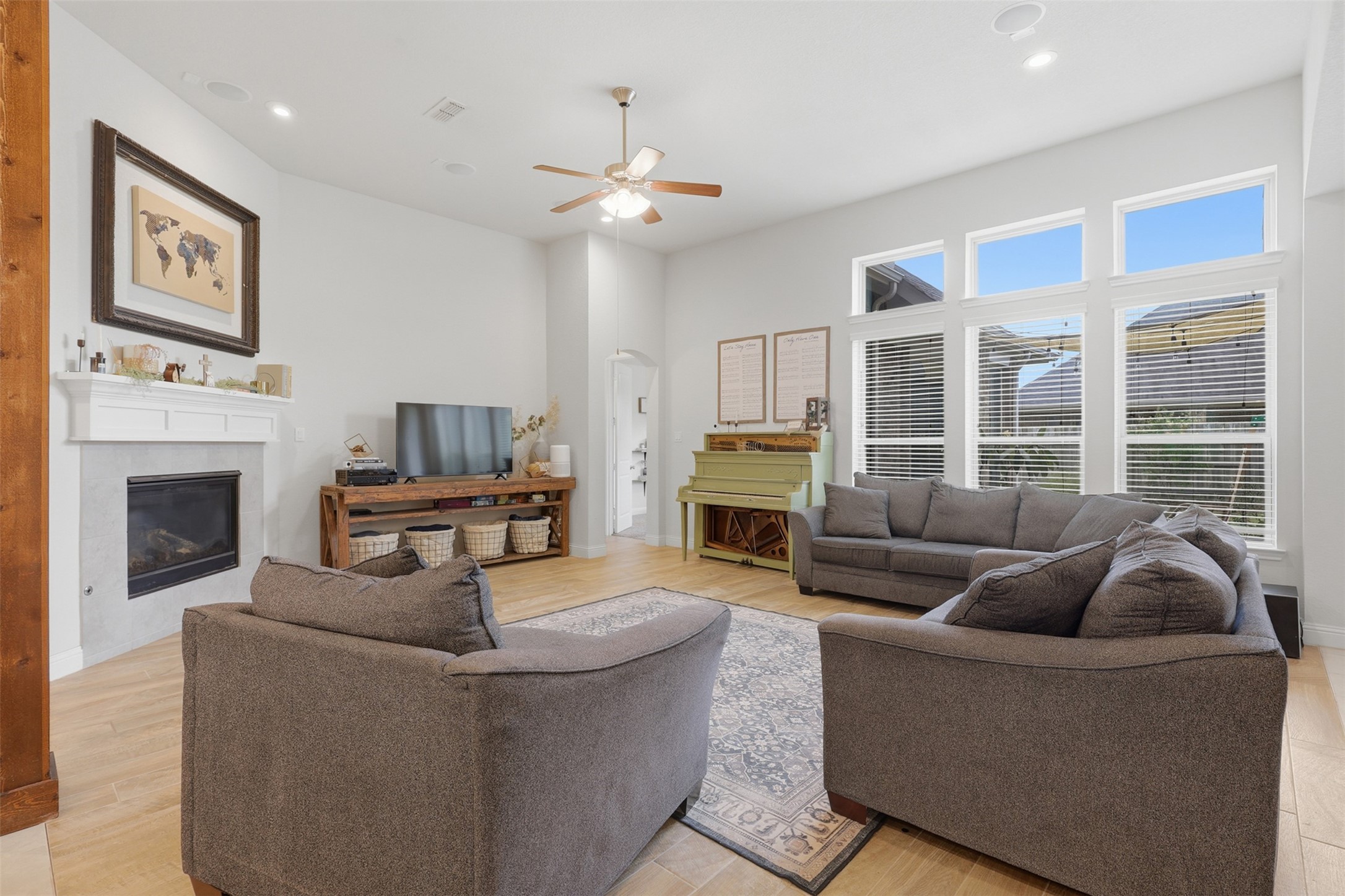 Expansive living room featuring a cozy fireplace and tall ceilings.