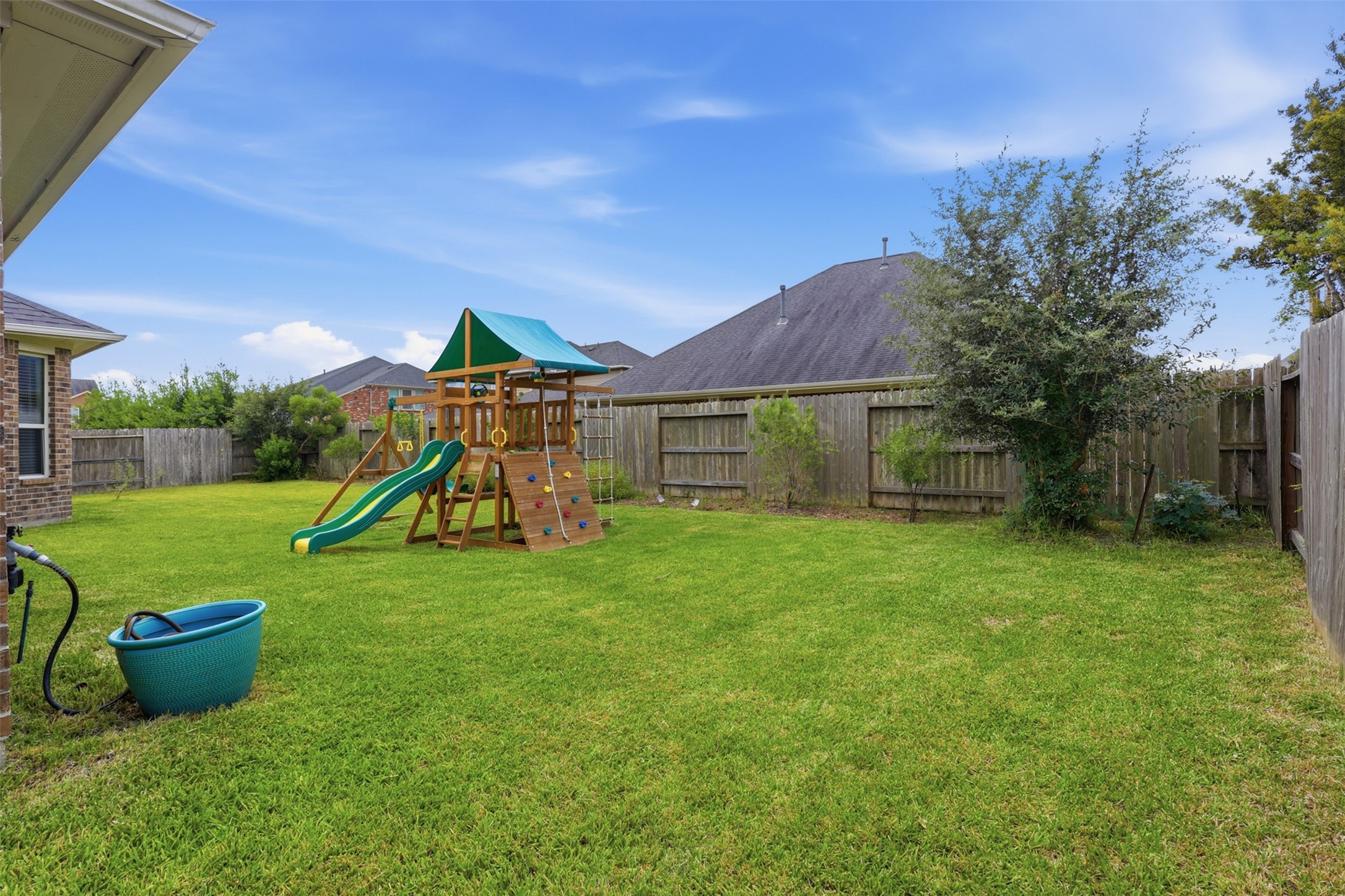 Expansive backyard offers endless possibilities for a pool, garden, or outdoor entertaining space.