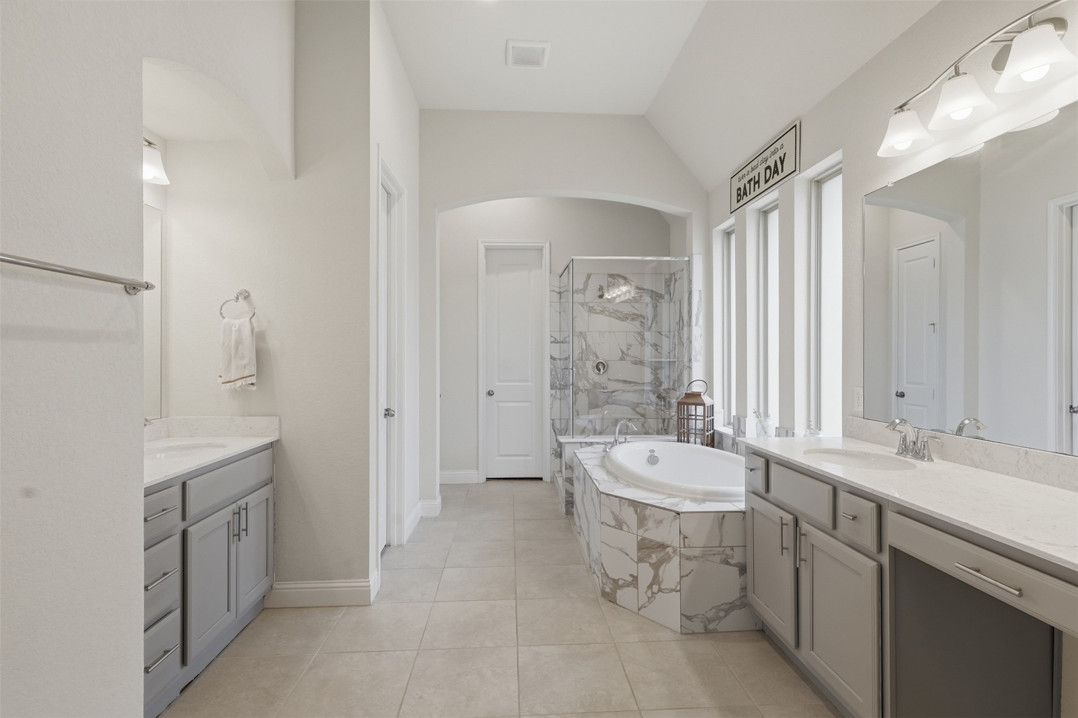 Separate vanity with additional storage and counter space.